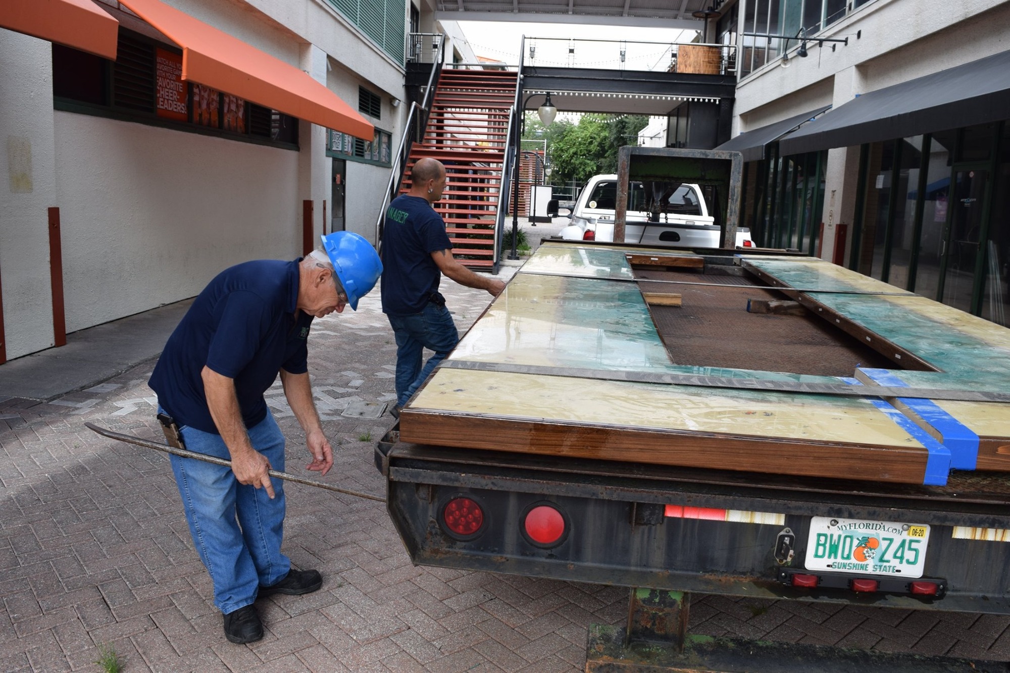 The Eco Relics team secures the bar top on a truck.