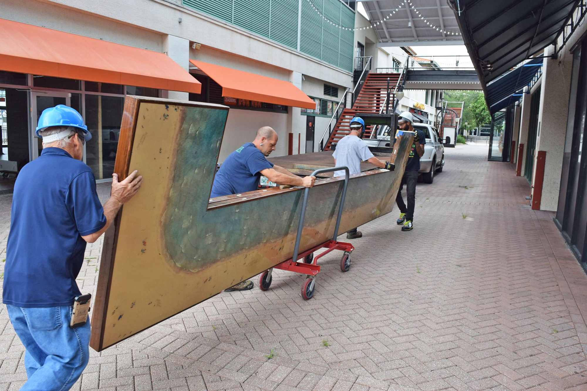 The Eco Relics team removes the bar top from Hooters restaurant at The Jacksonville Landing in August.