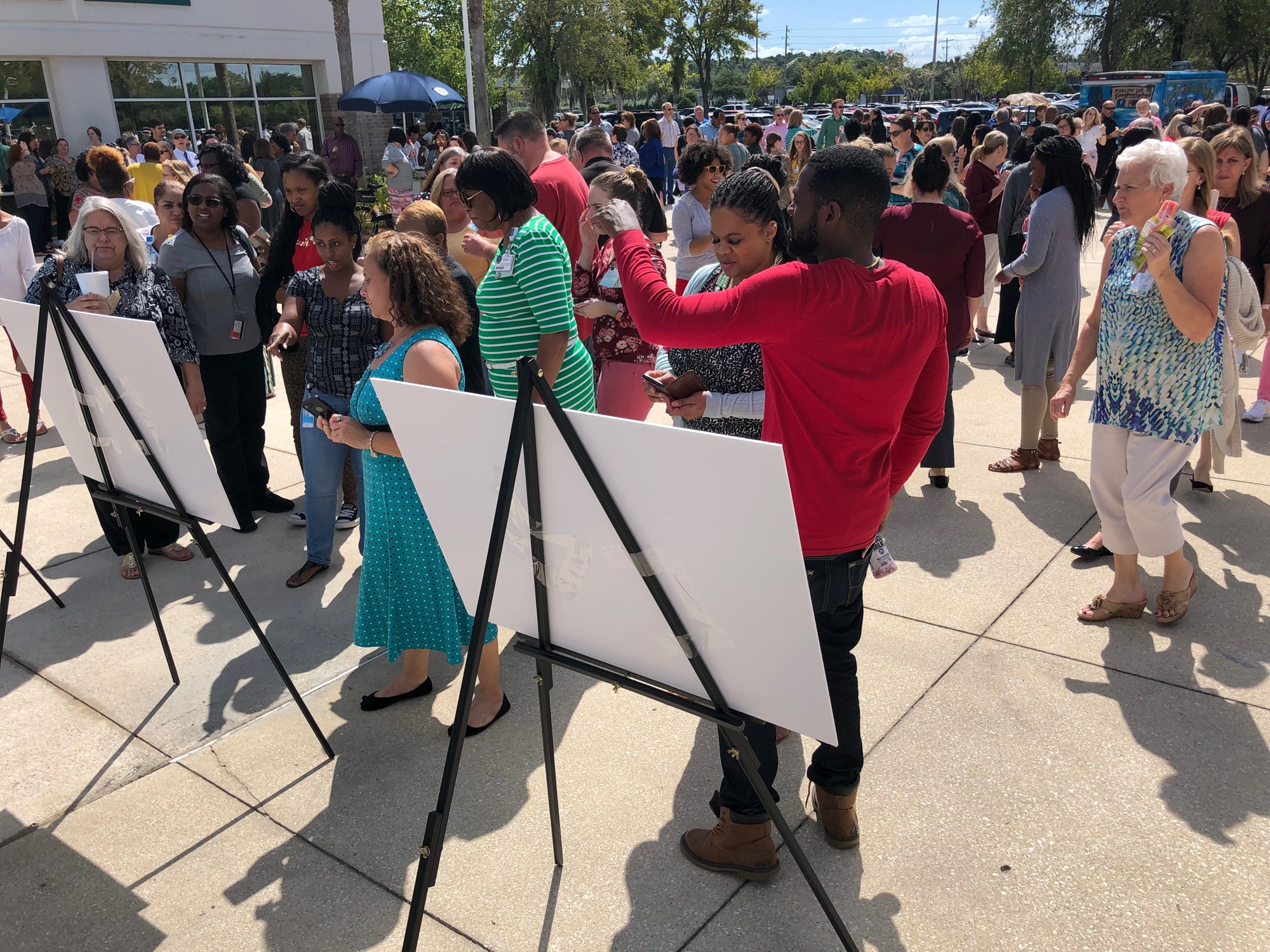 Employees at what was called Metro Square look at the logo for San Marco East Plaza.