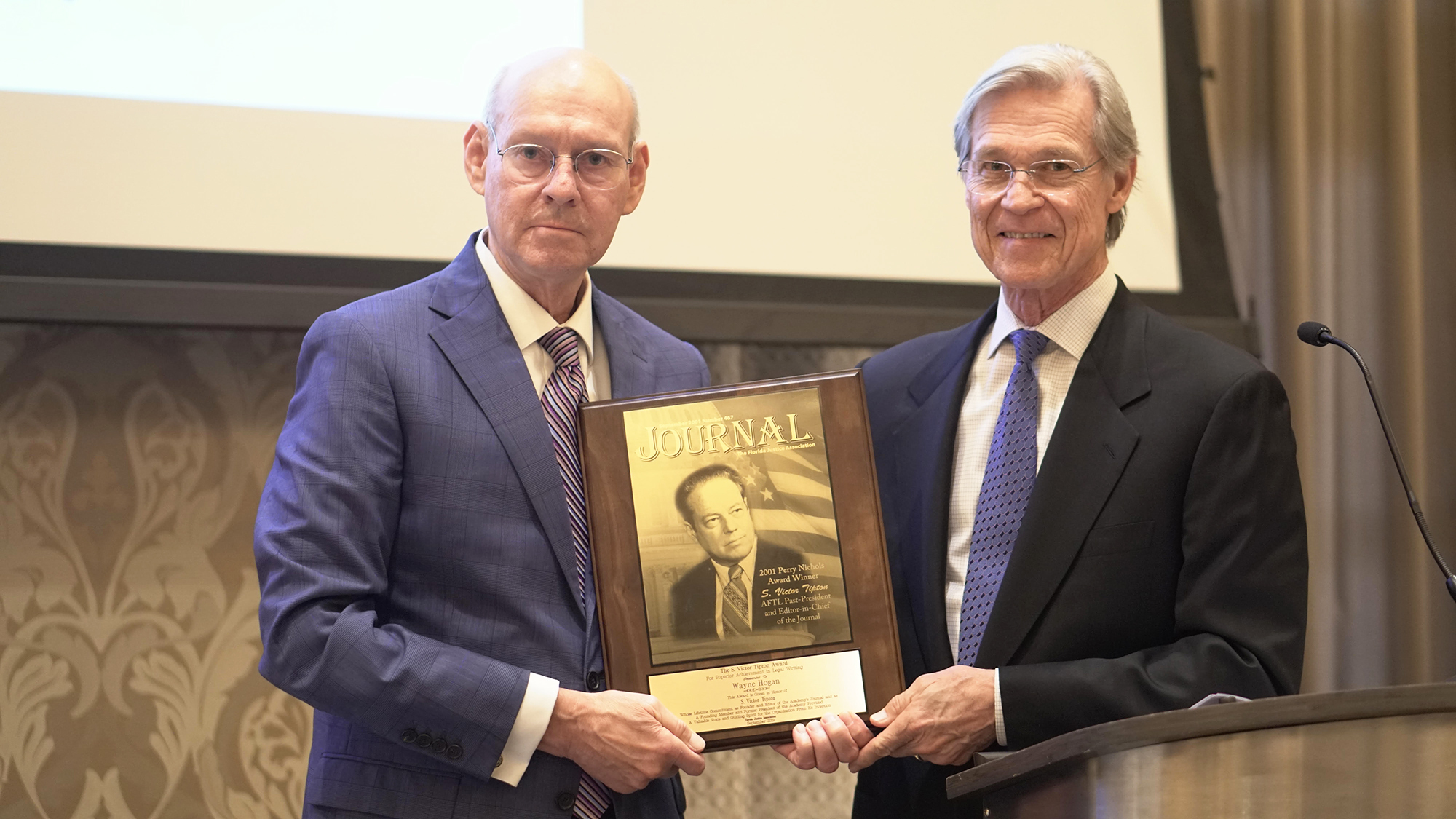 Florida Justice Association Executive Director Paul Jess, left, and attorney Wayne Hogan, recipient of the association’s S. Victor Tipton Award.