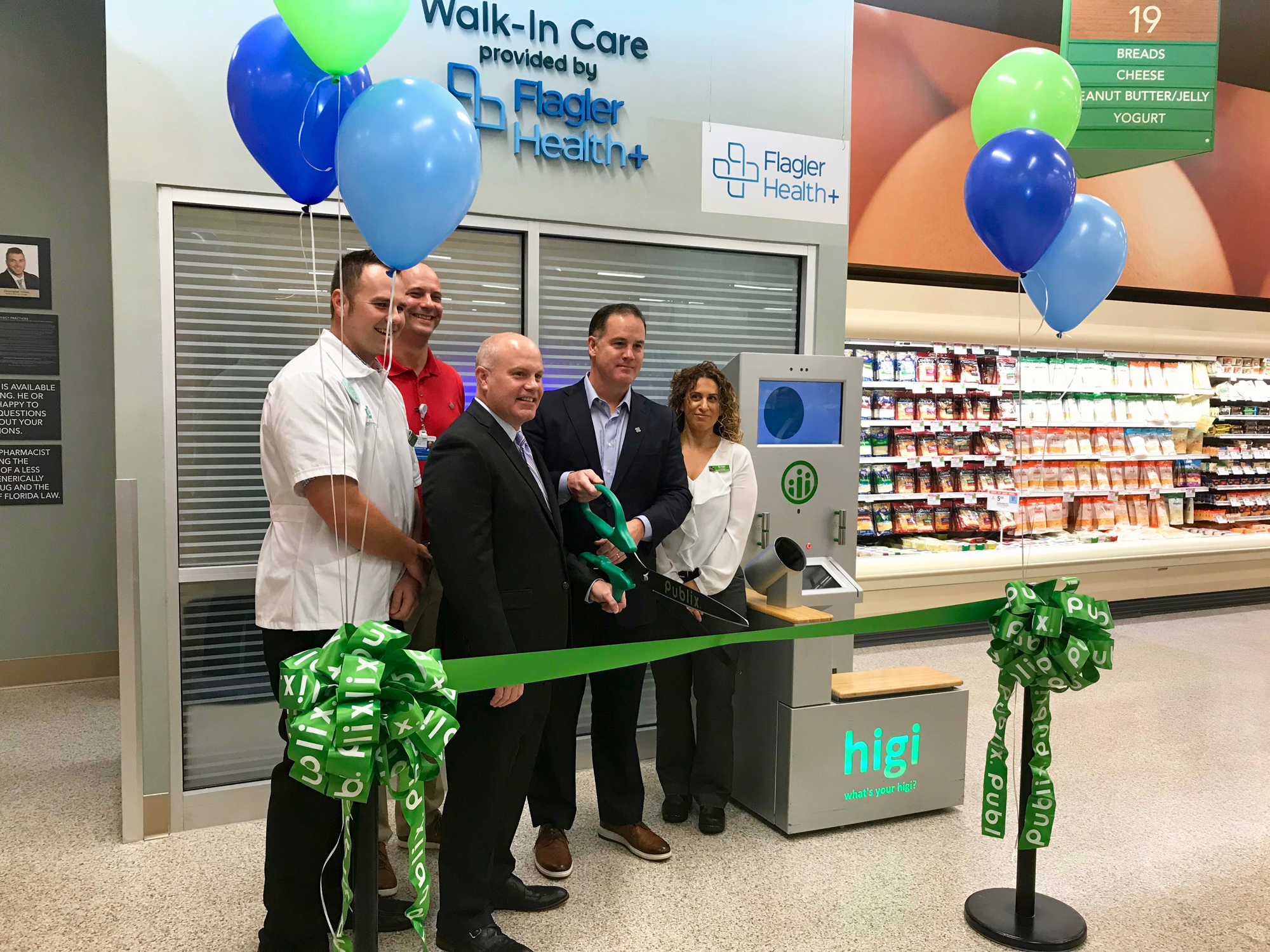 Officials prepare to cut the ribbon at the grand opening of the telehealth kiosk at the Publix supermarket in Nocatee.