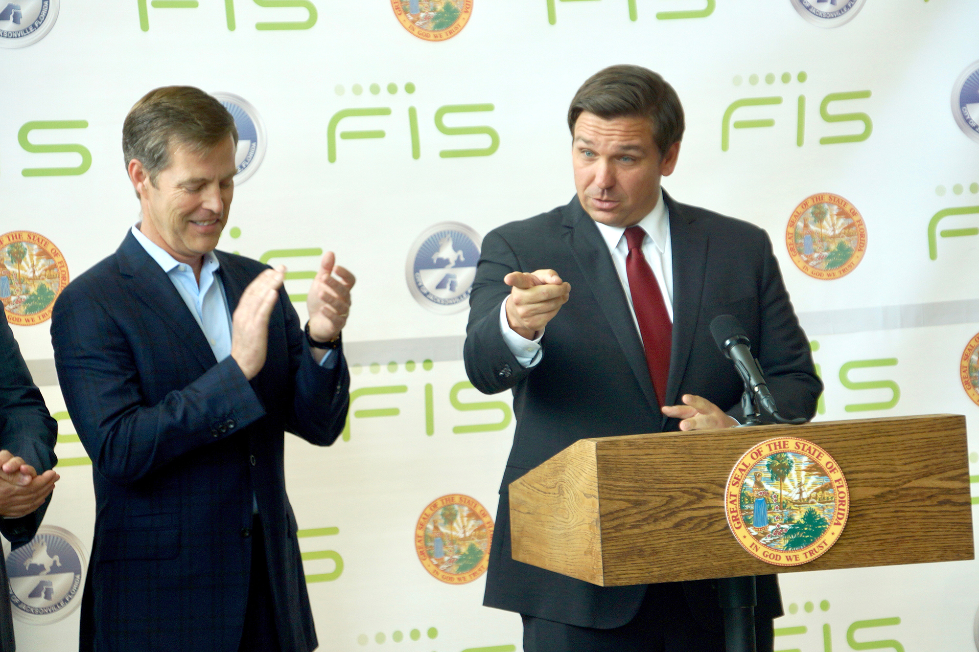 Fidelity National Information Services Inc. Chairman, President and CEO Gary Norcross and Gov. Ron DeSantis. right, announce the new headquarters Friday.