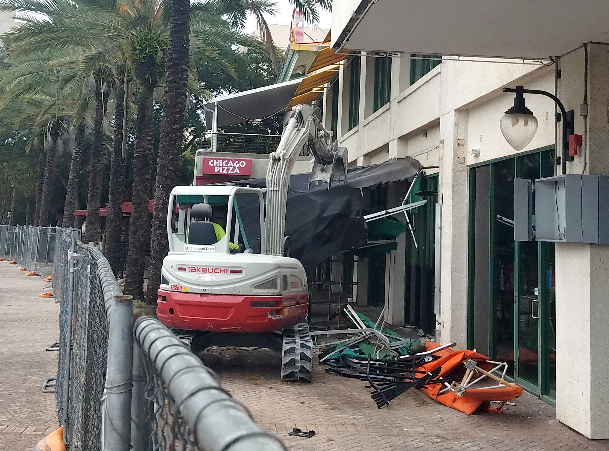 Workers tear down the awning near Chicago Pizza at The Jacksonville Landing on Tuesday.