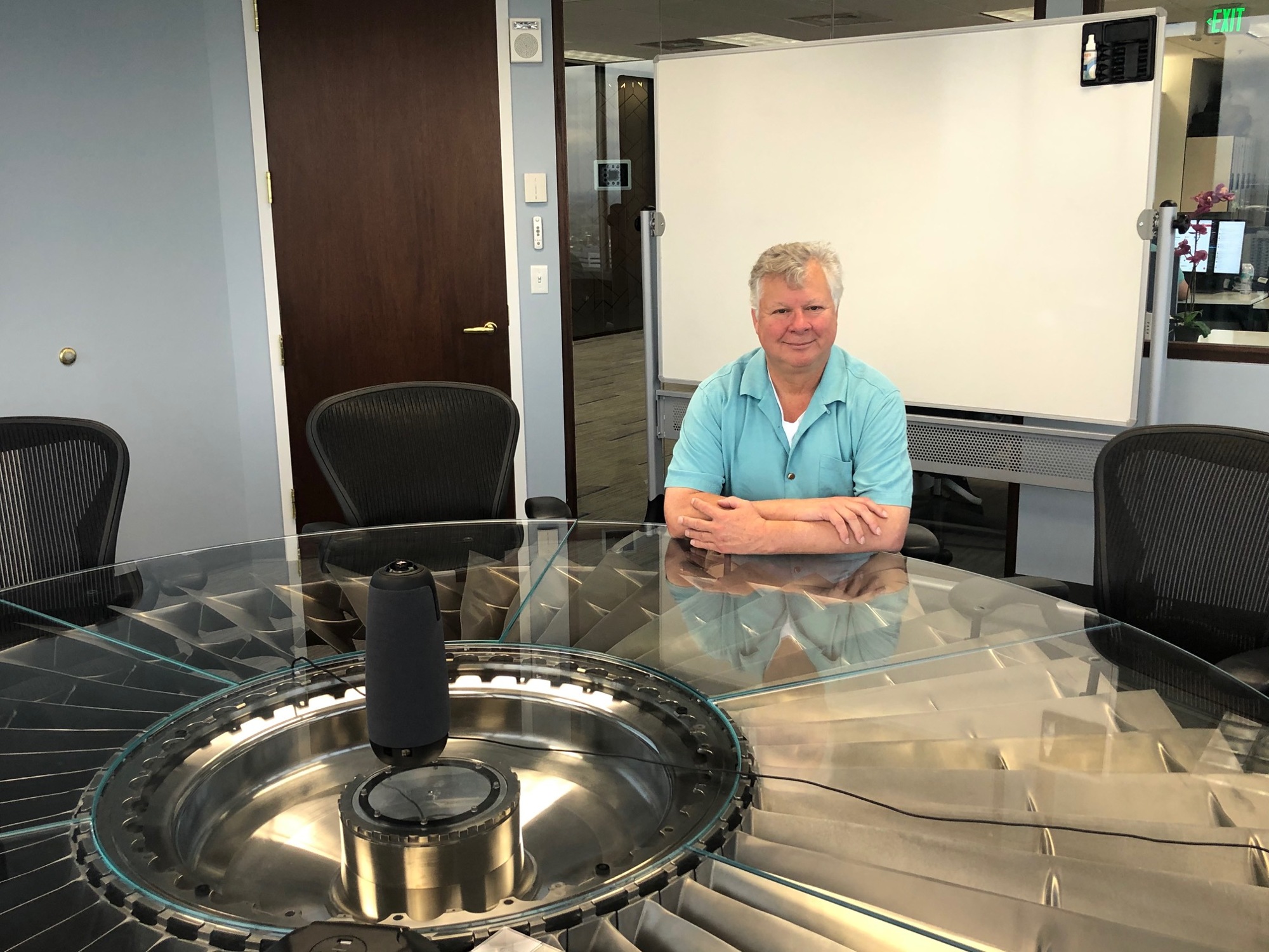 Finxact CEO Frank Sanchez sits at the company’s conference table built atop a turbofan from a Boeing 747 jet.
