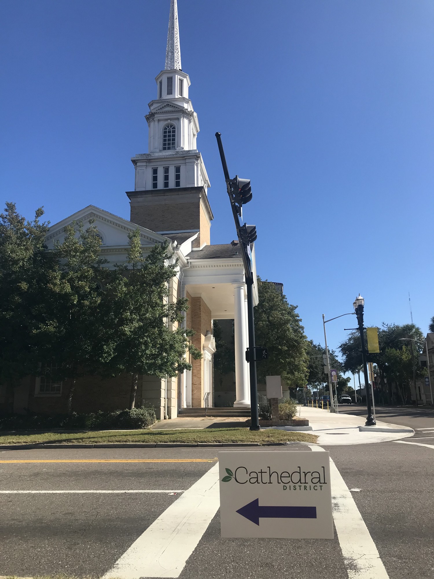 A sign points to the next destination in front of First United Methodist Church.