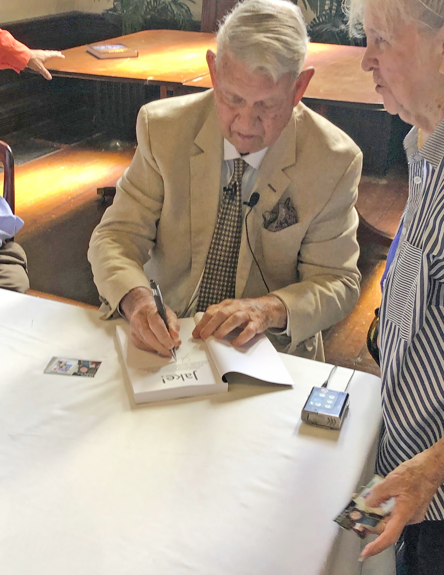 Jake Godbold signs a copy of his book “Jake!” written with former aide and strategist Mike Tolbert in August.