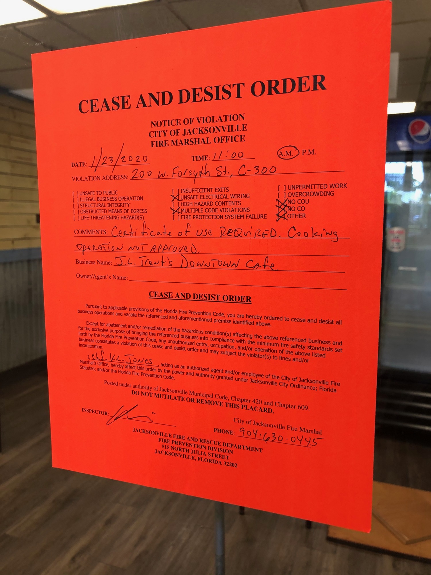A cease-and-desist order posted on the window of the restaurant.