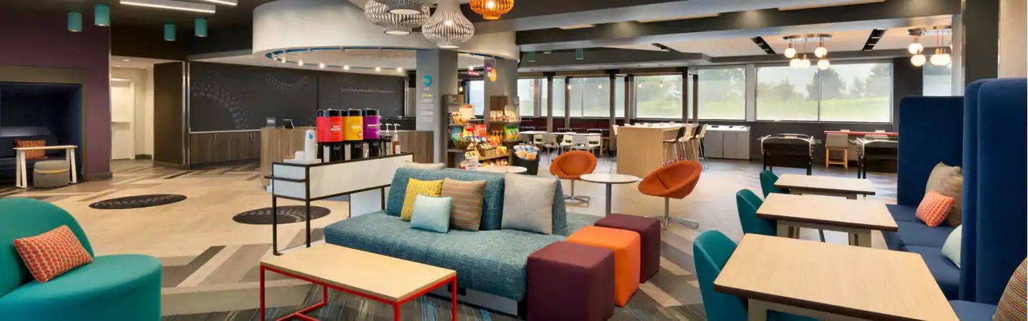 Tru by Hilton offers a lobby with workspaces along with activities like pool, foosball and board games.