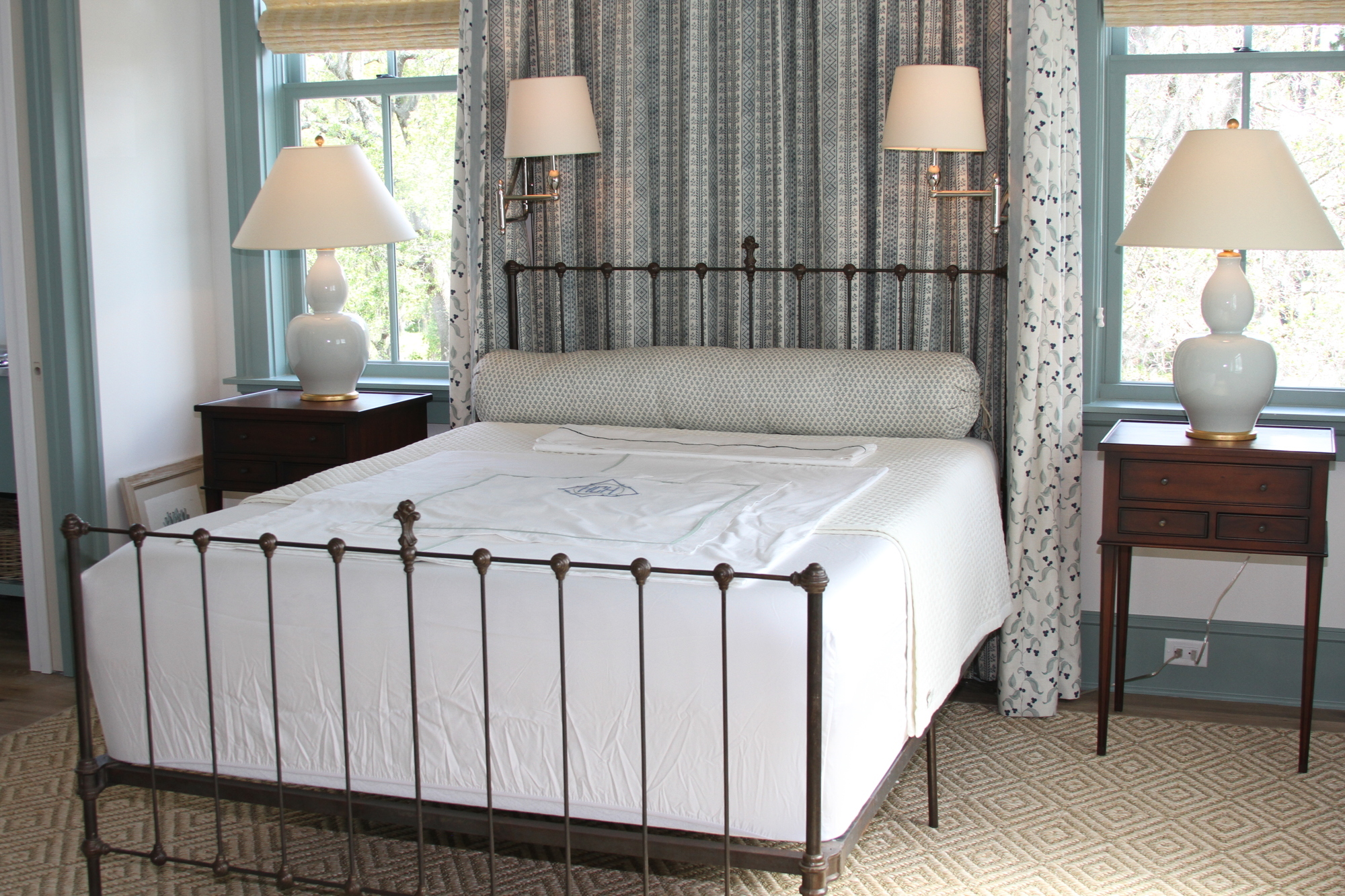 A bed features a handprinted design on natural linen, designed by Heather Chadduck Hillegas.