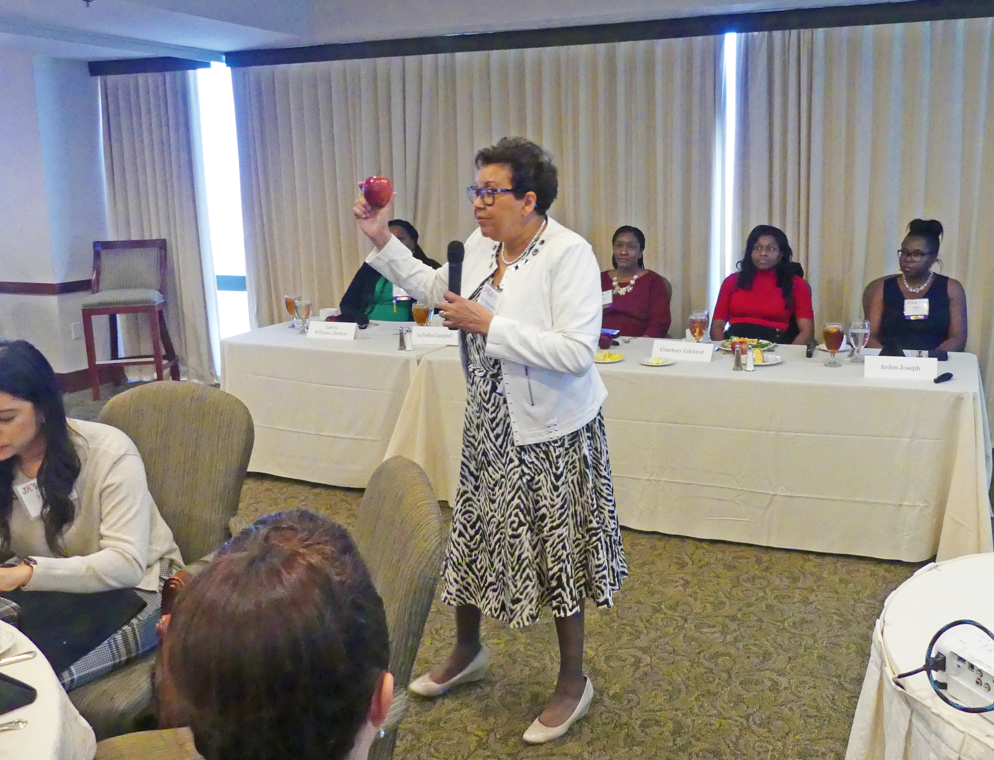 Duval County Judge Pauline Drake used an apple to illustrate the theme of the Jacksonville Women Lawyers Association's discussion at its meeting Feb. 13 at The River Club.
