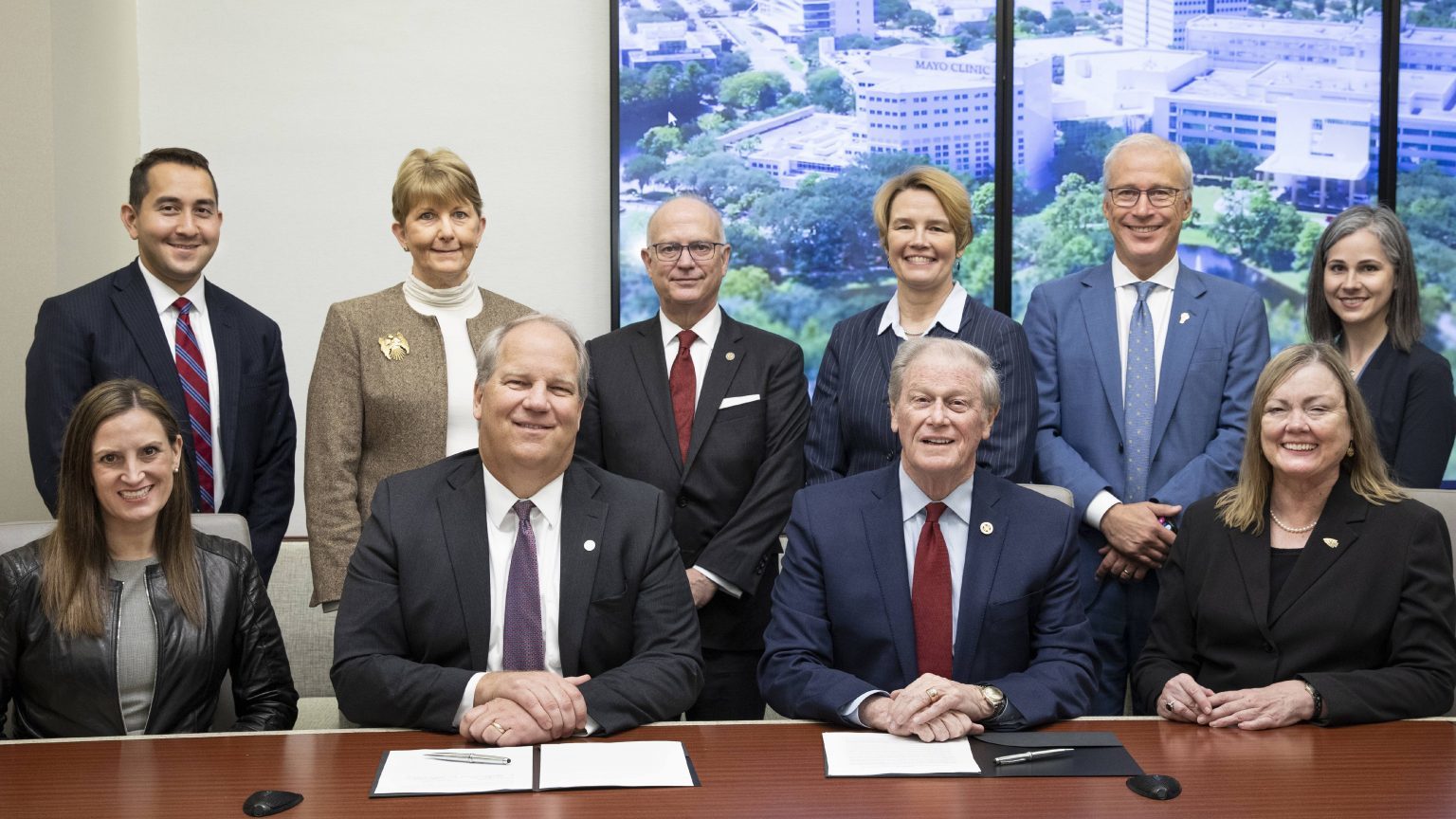 Mayo Clinic Florida CEO Kent Thielen and FSU President John Thrasher, seated center, announced the collaborative education effort Feb. 25.