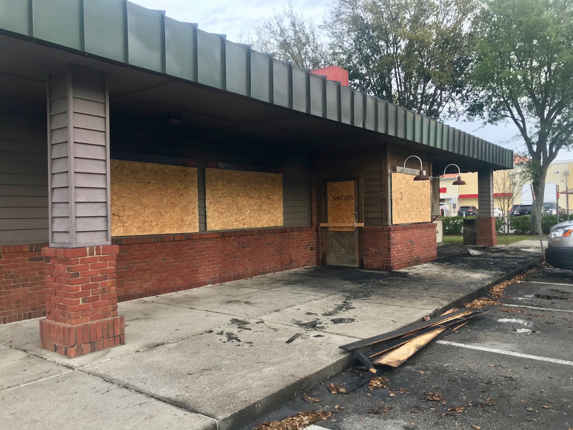 Windows were boarded up Tuesday morning following the Monday night fire at Bono's Pit Bar-B-Q on Gate Parkway.