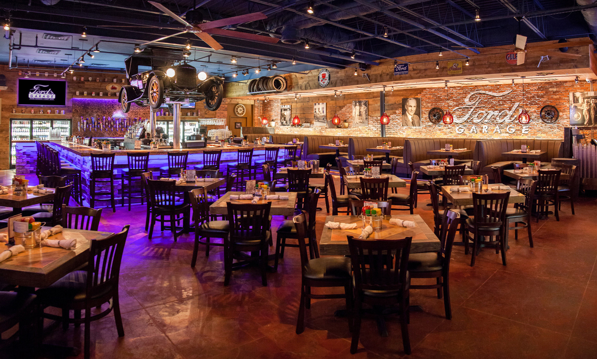 The dining area at Ford's Garage restaurant features vintage cars and decor.