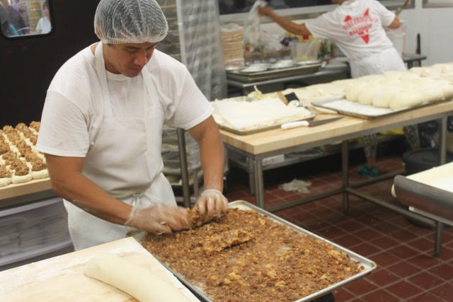 Ariosto Valerio Jr. prepares the filling for his bakeshop’s pork siopao asada, which are meat-filled steamed buns.