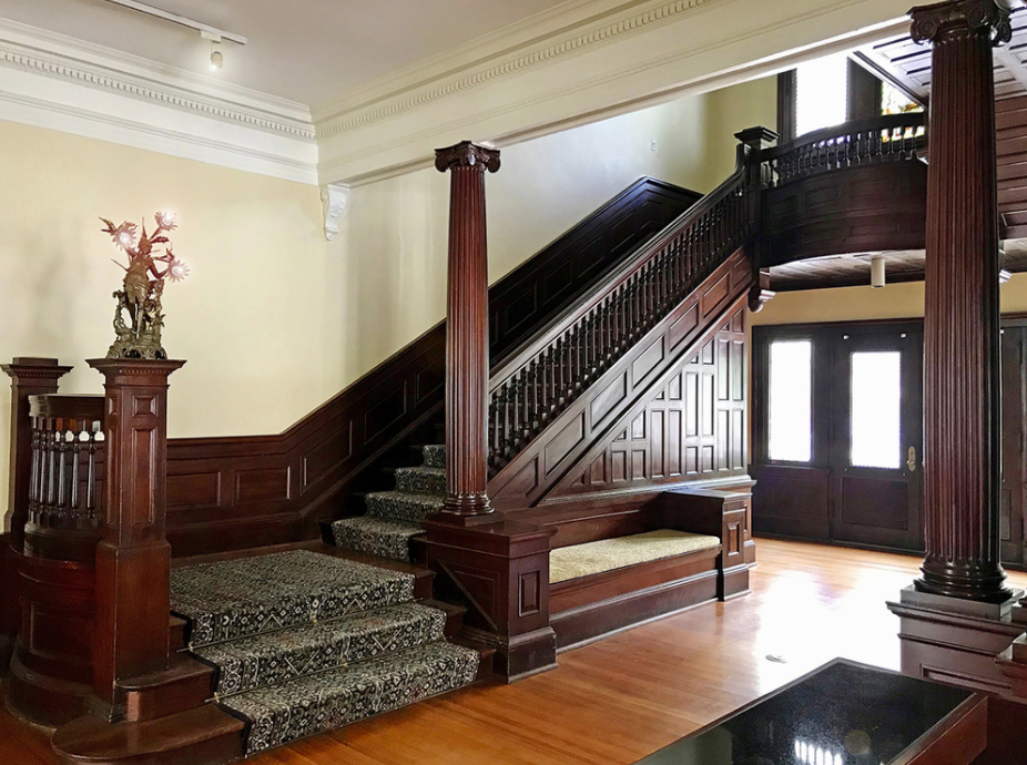 Grand staircases with mahogany trim are featured inside the Porter House Mansion. (NAI Hallmark)