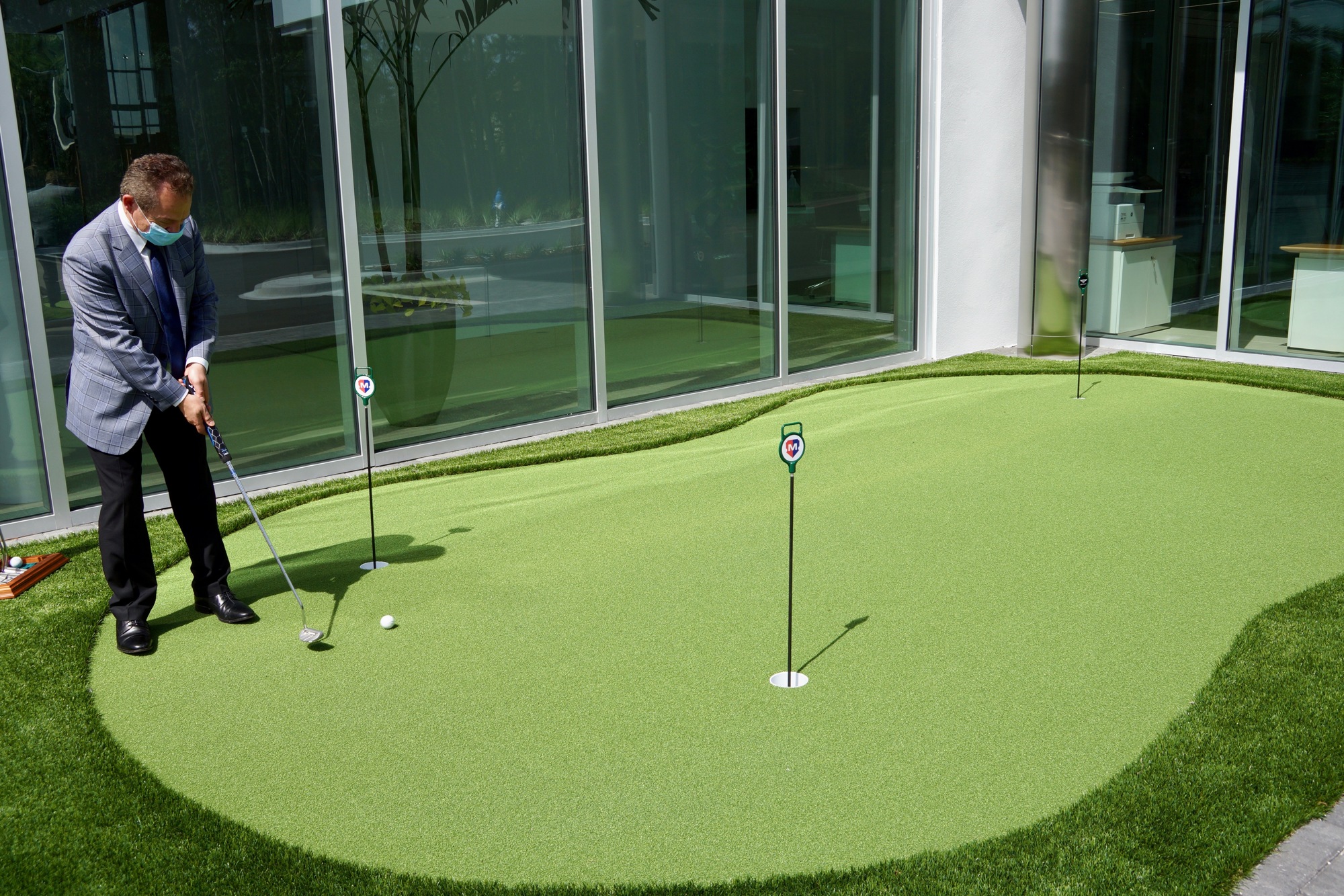 General Manager TJ Samhouri plays on the putting green outside of Bentley Jacksonville.  (Photo by Katie Garwood)