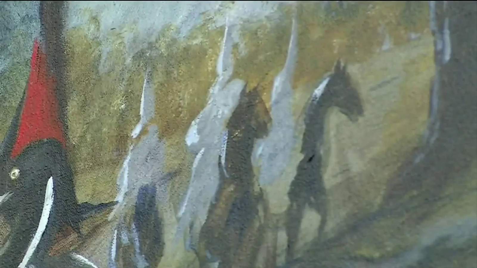 The mural includes this image of three Klan members on horseback.