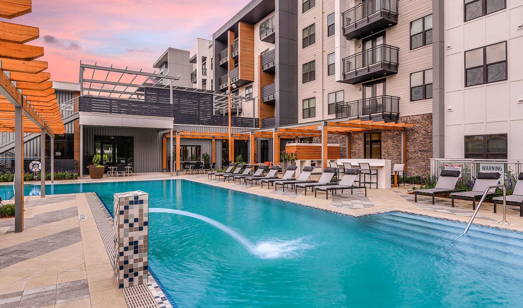 The pool area at JTB Apartments.