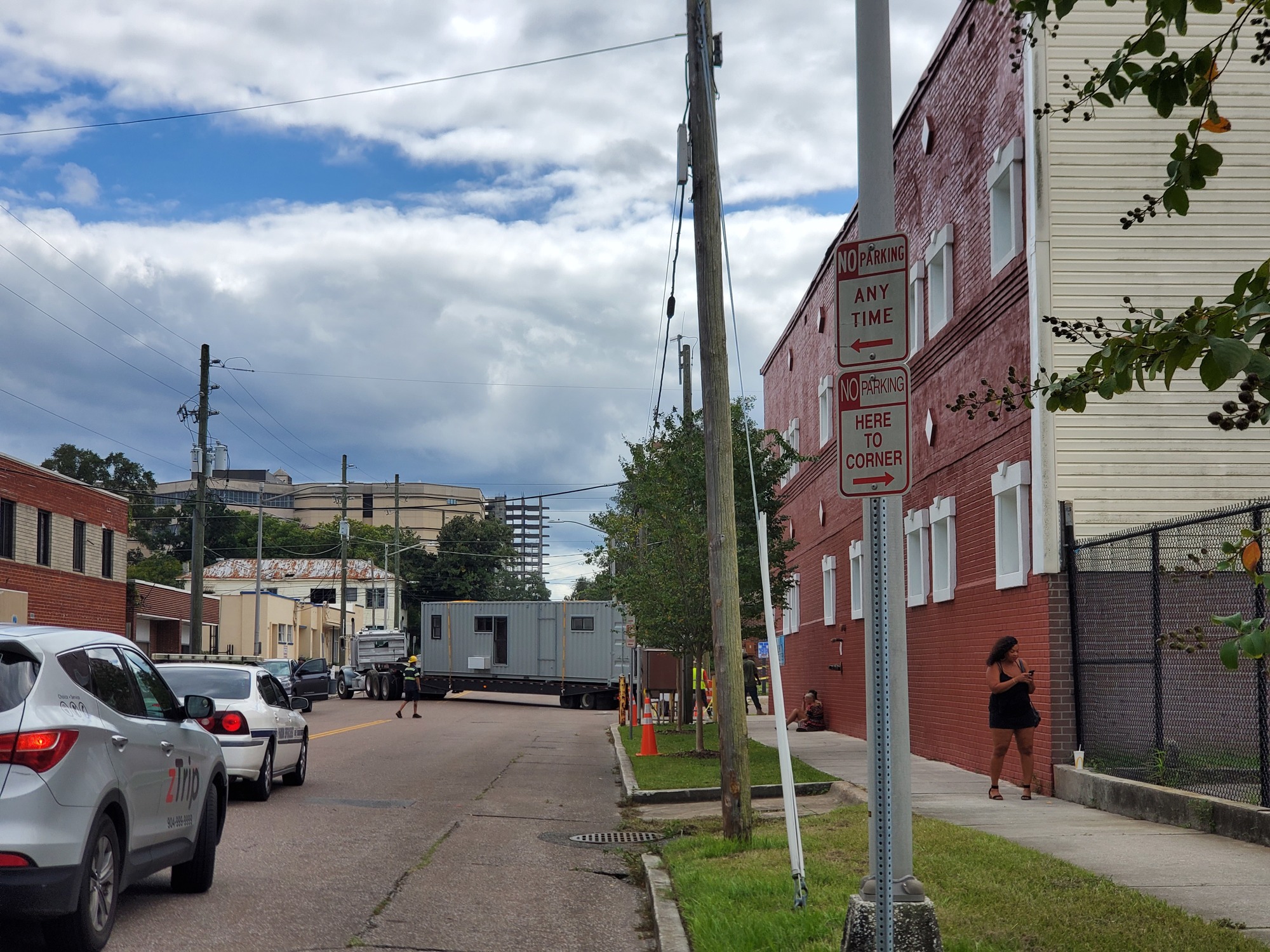 A shipping container apartment unit on a flatbed truck is maneuvered into place Sept. 18,  The community is being constructed at 412 E. Ashley St. in the Downtown Cathedral District.