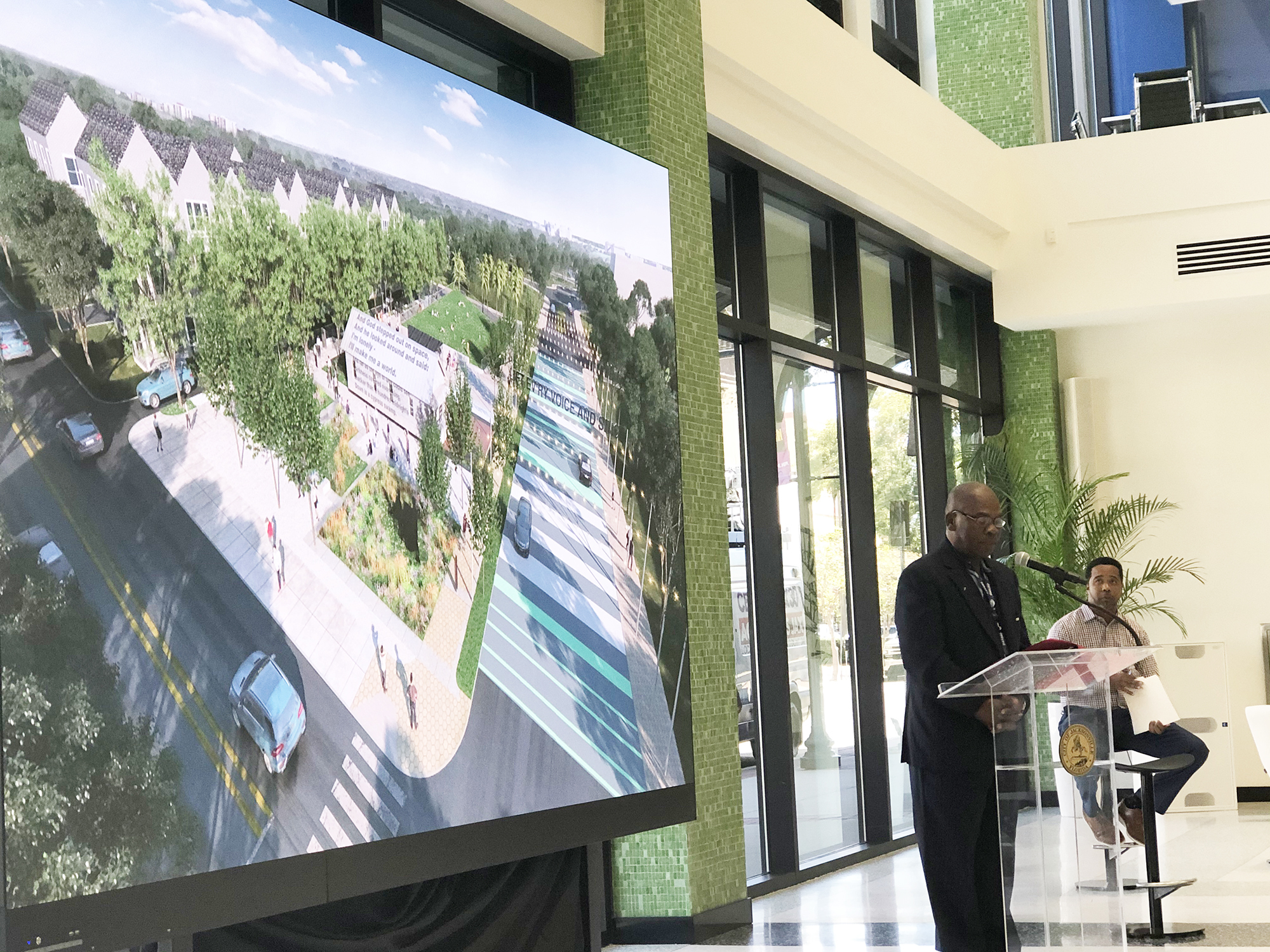 District  7 Council member Reggie Gaffney speaks while city Parks, Recreation and Community Services Department Director Daryl Joseph watches during the reveal presentation.