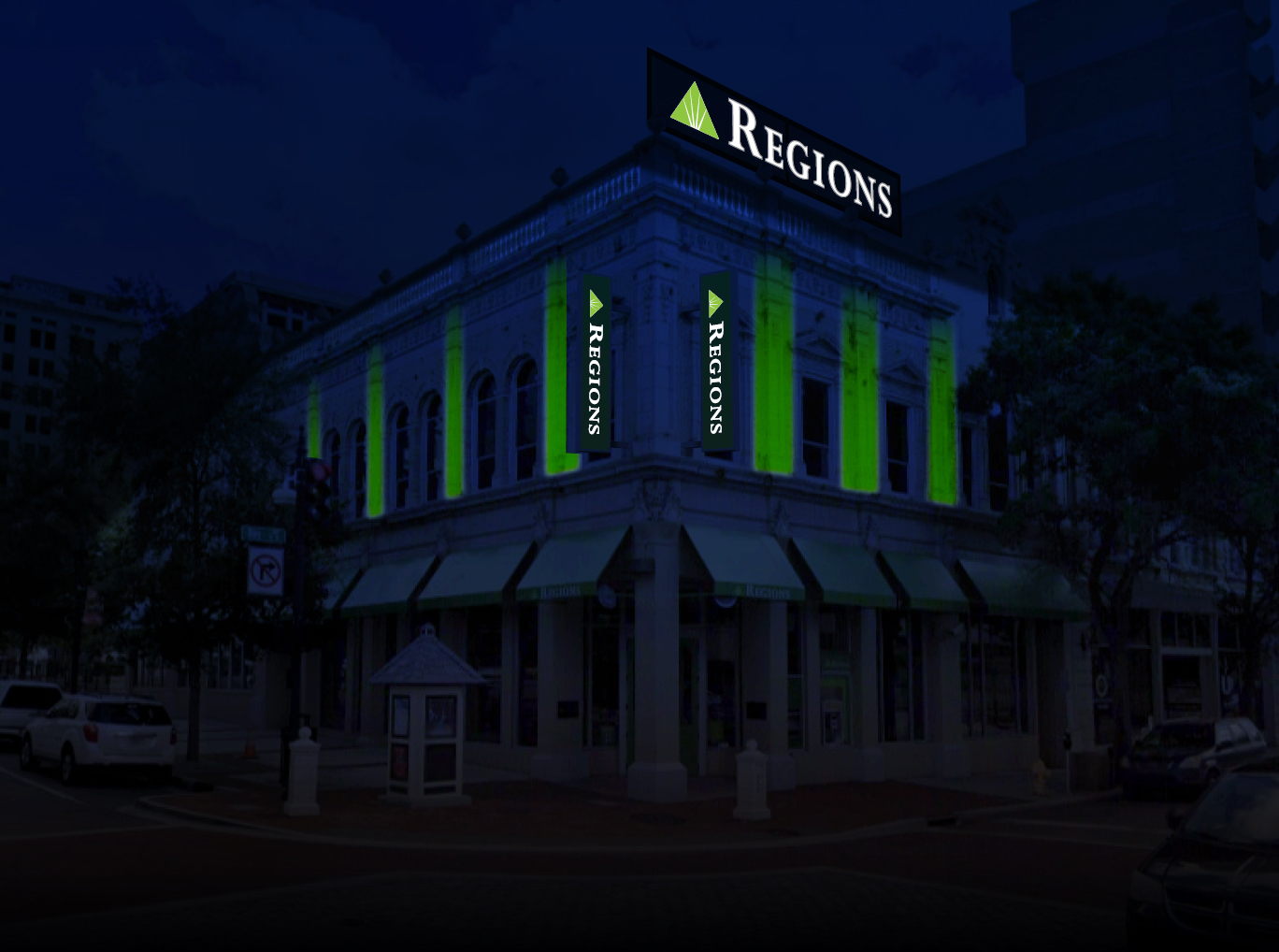 The Regions signs at night.