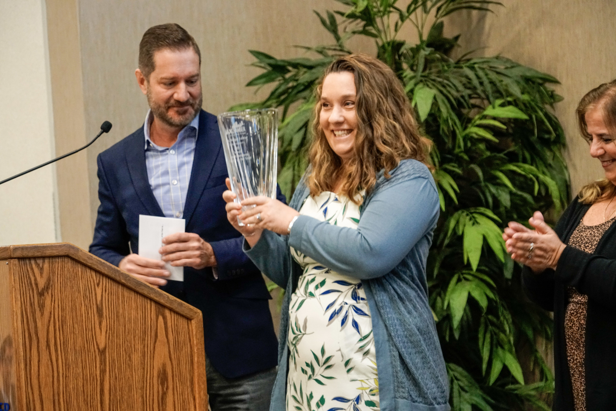 Sláinte Chiropractic owner Bridget Edkin accepts the 2021 JAX Chamber Small Business Leader of the Year award on Feb. 2 from last year’s winner, Martin Coffee Co. owner Ben Johnson.