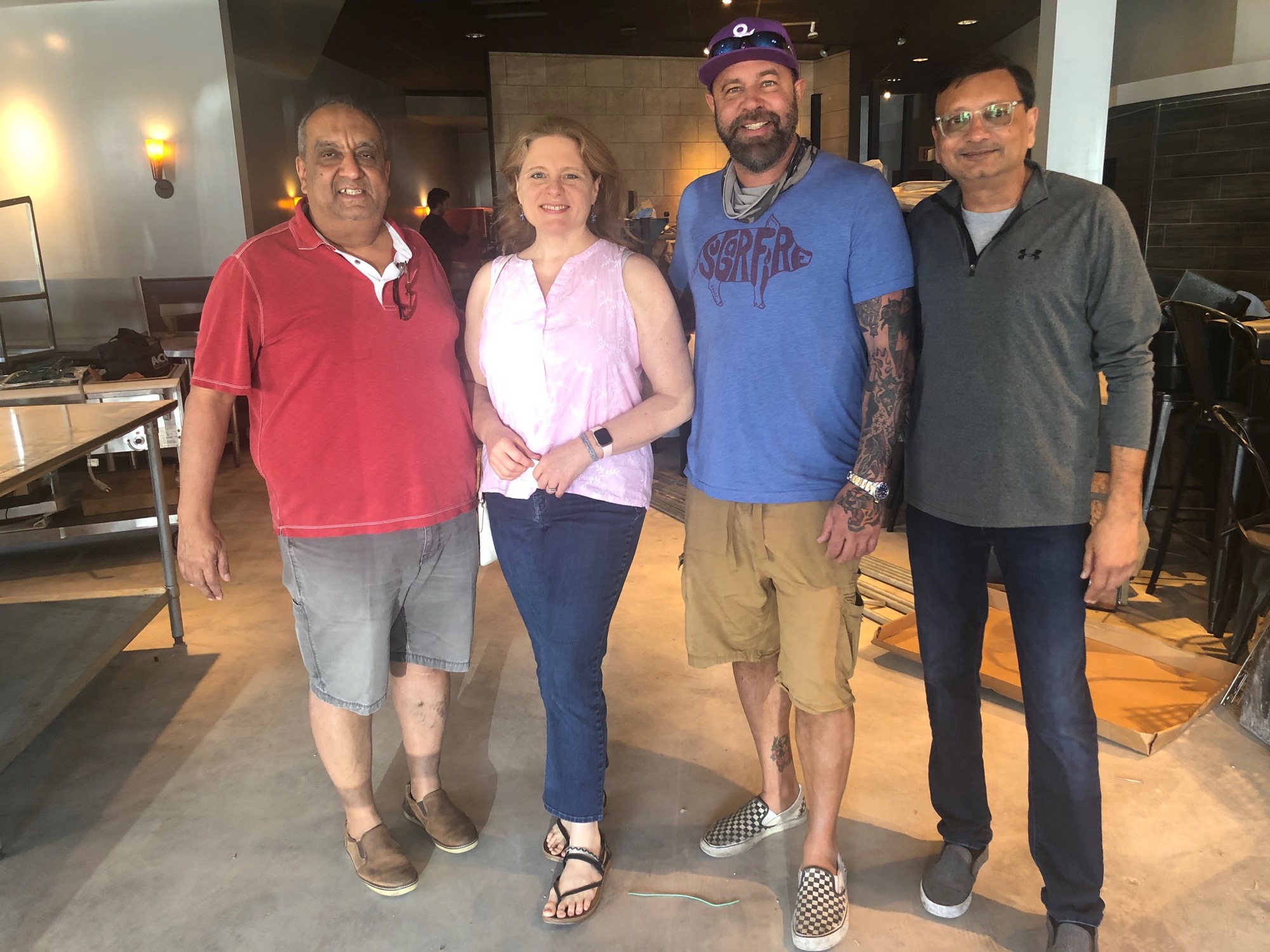 From left, Florida franchise owners Anil and Juli Dharna and, at right, Shy Patel with Sugarfire Smoke House founder Mike Johnson.