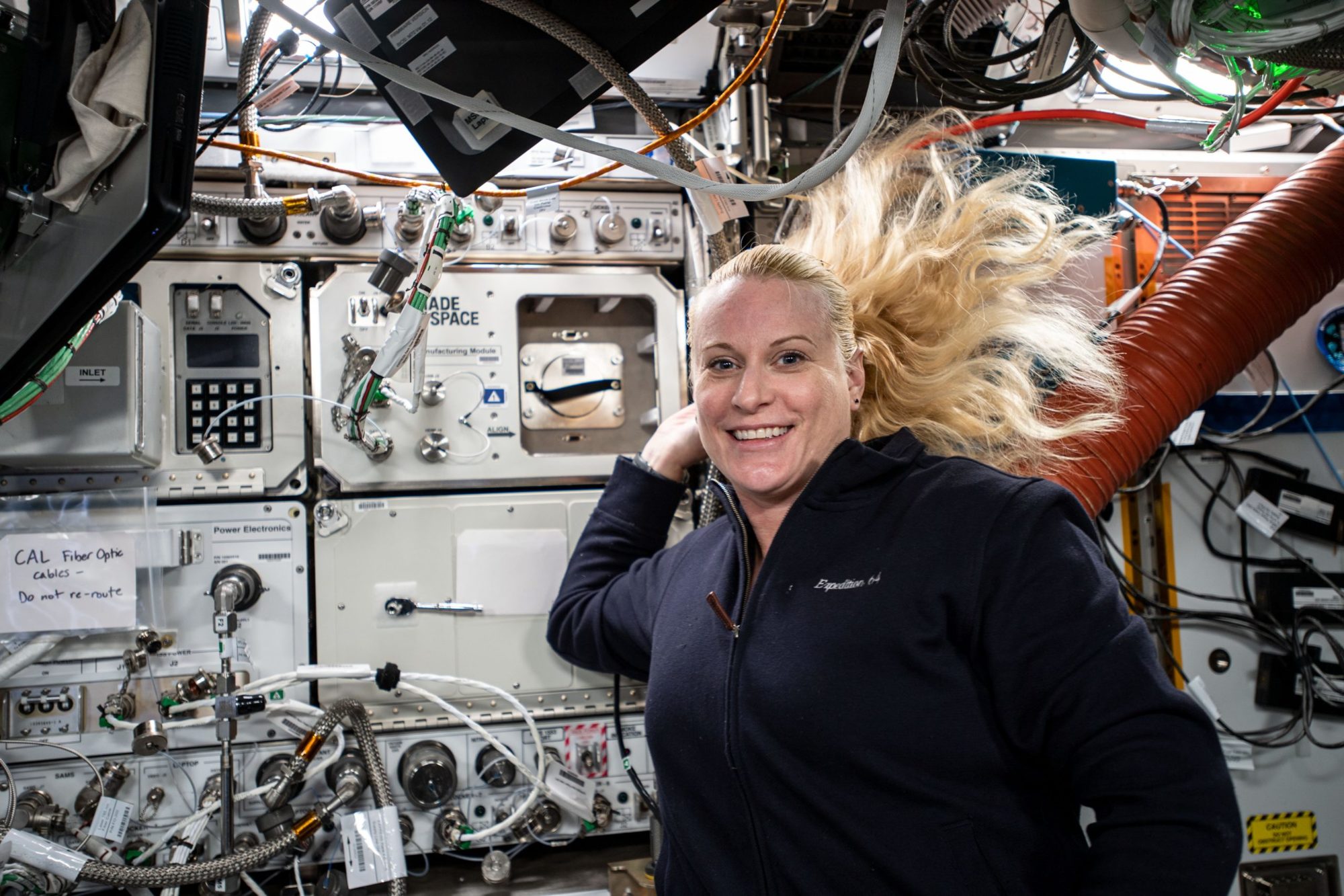 NASA engineer Kate Rubins with a 3D printer made by Made In Space, now named Redwire, aboard in International Space Station.