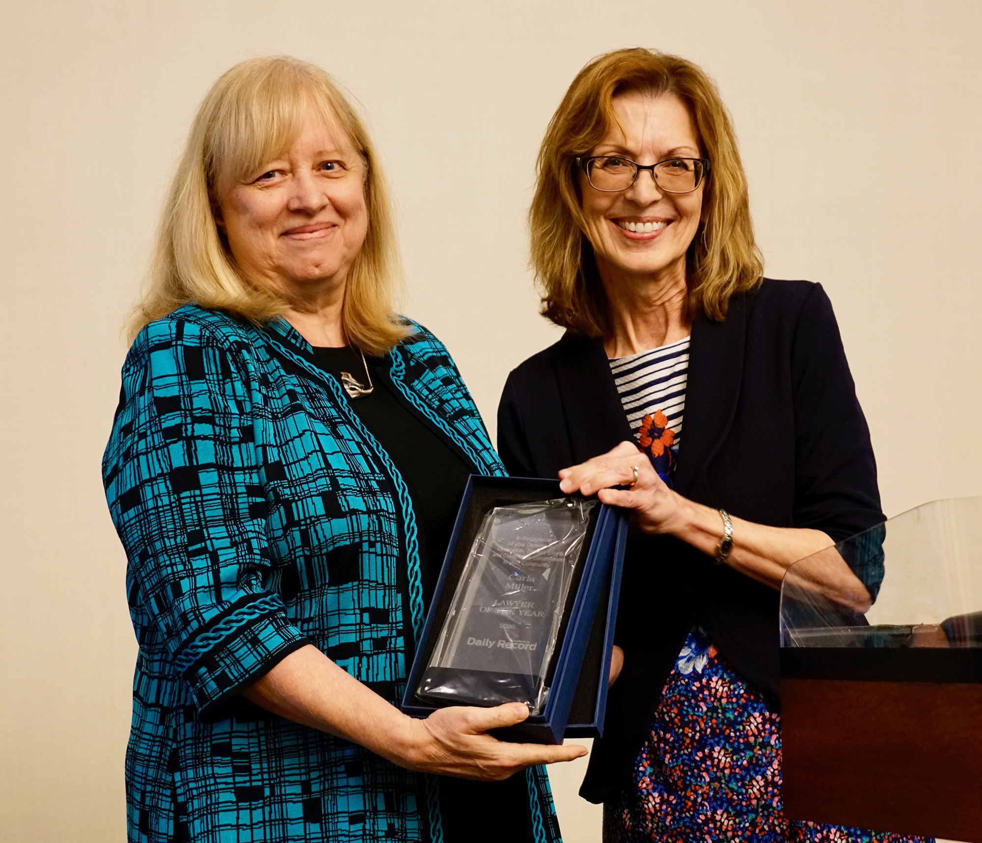 Carla Miller, the 2020 Jacksonville Daily Record Lawyer of the Year, accepts her award in person from Editor Karen Brune Mathis. The Law Day luncheon was virtual last year because of COVID-19.
