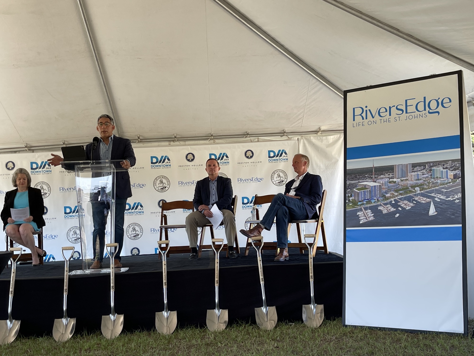 Preston Hollow Capital Managing Director Ramiro Albarran speaks at a May 25 groundbreaking ceremony. At left is DIA CEO Lori Boyer. At right are Mayor Lenny Curry and Preston Hollow CEO and founder Jim Thompson.