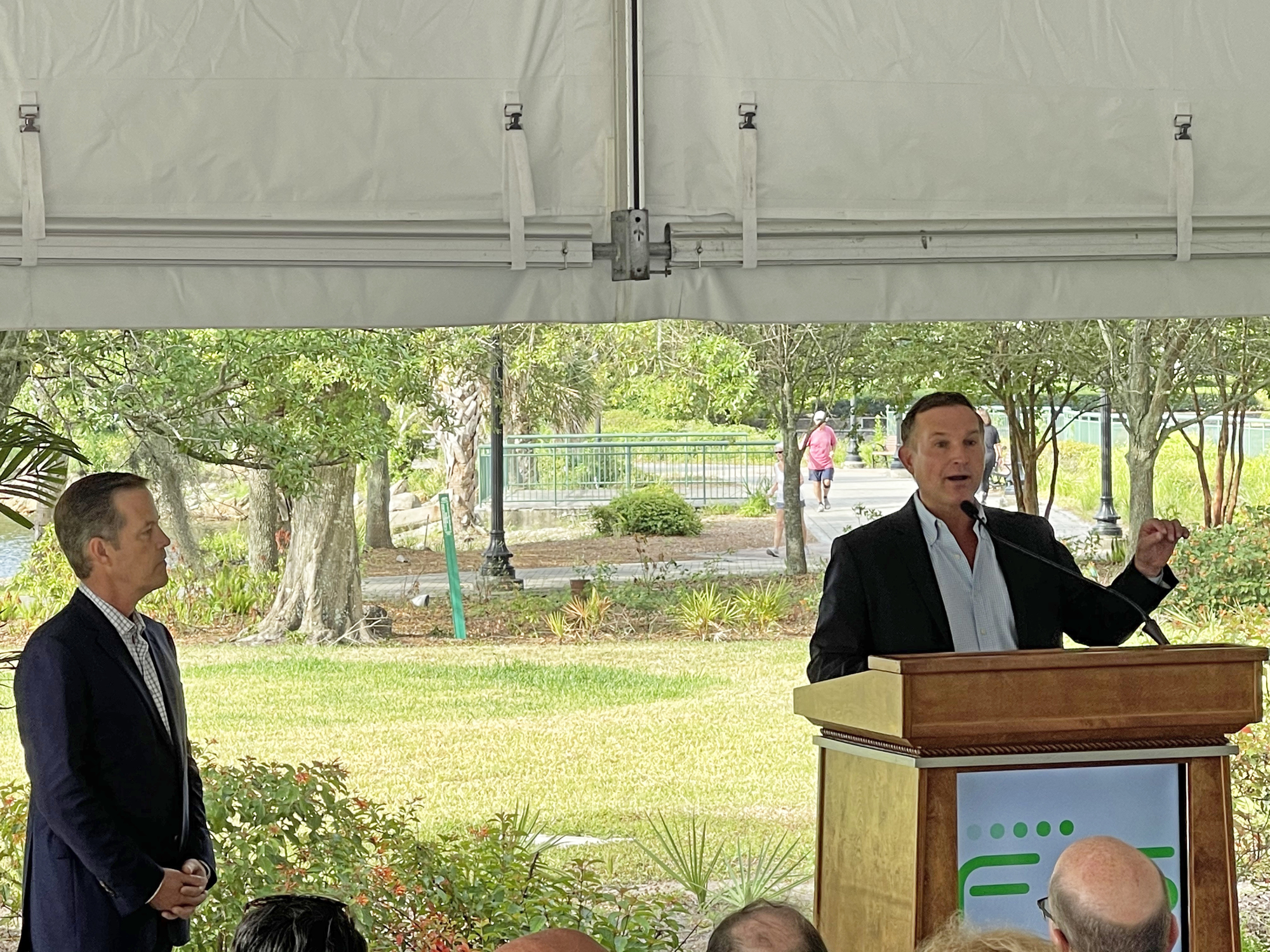 Mayor Lenny Curry speaks at the topping off ceremony while FIS CEO Gary Norcross watches.