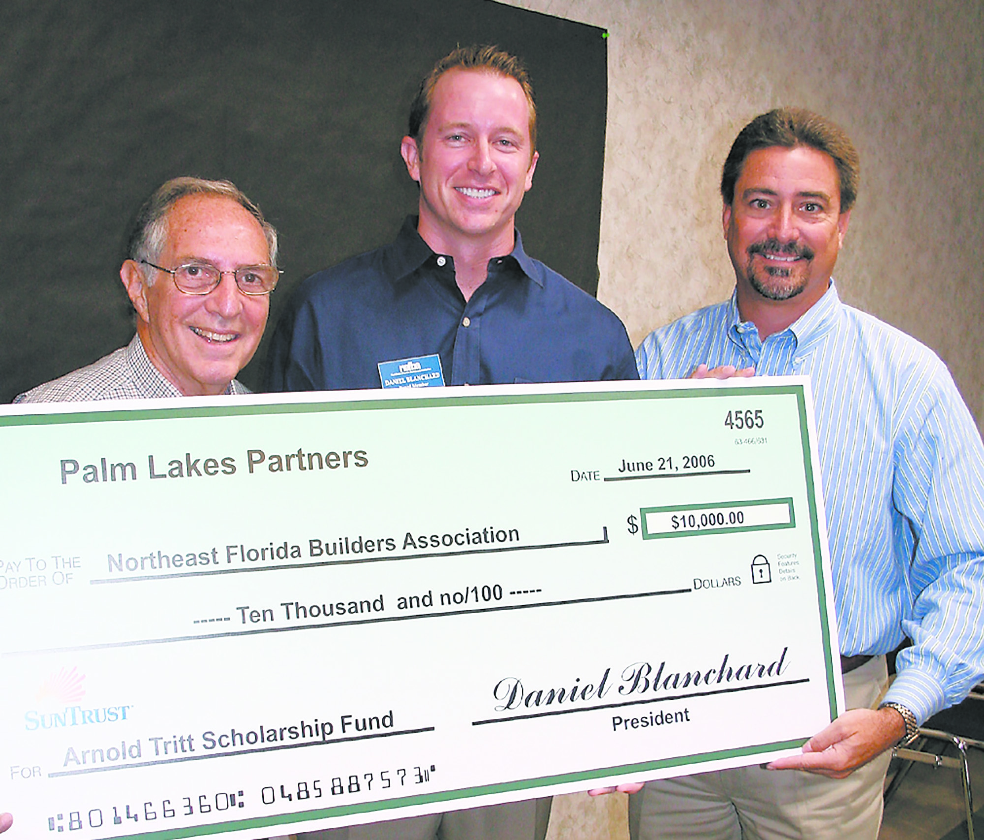 Arnold Tritt accepts a check for the Arnold Tritt Scholarship Fund from Daniel Blanchard and Glenn Layton.