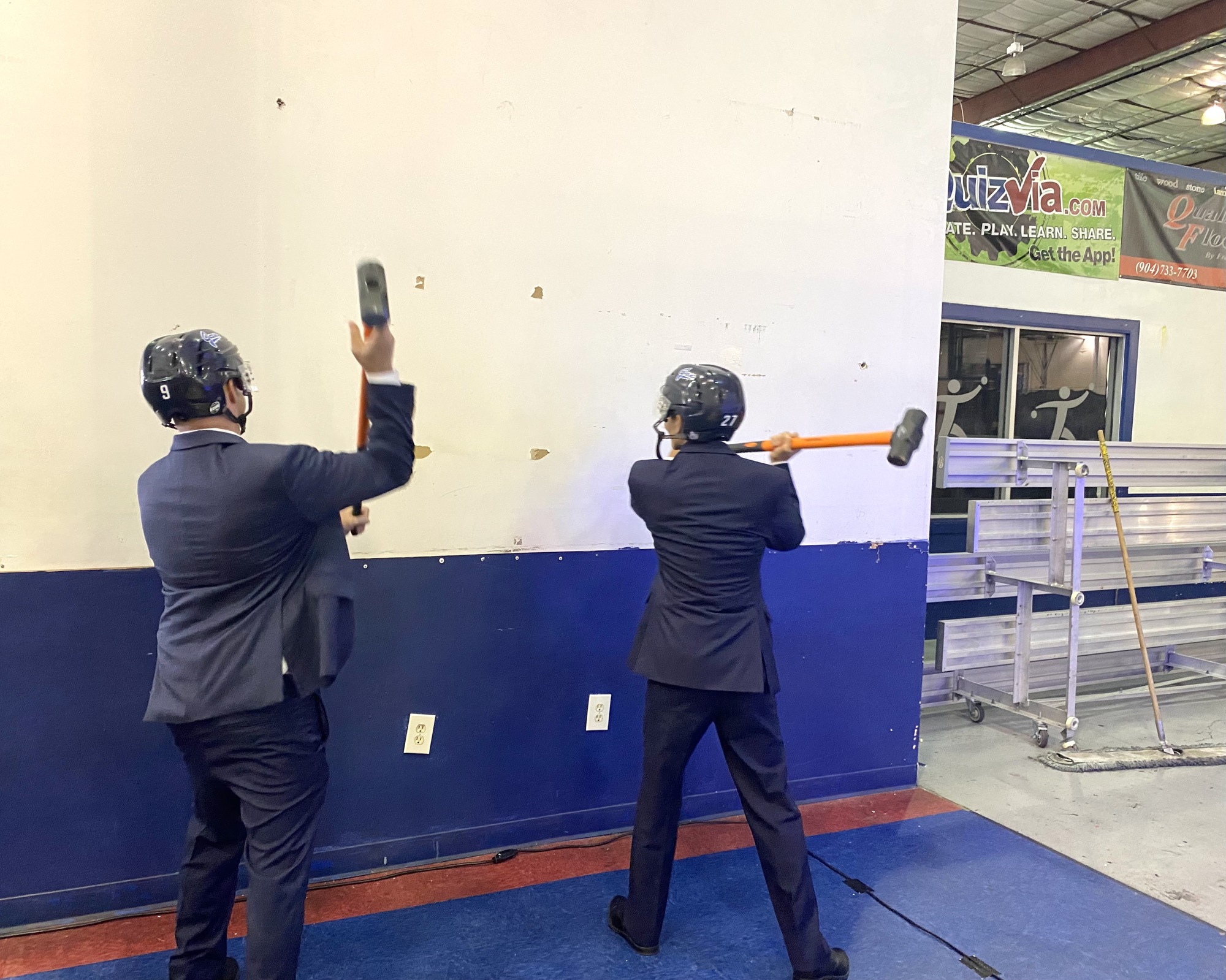 Icemen majority owner Andy Kaufmann and Community First President and CEO John Hirabayashi use sledgehammers to begin demolition at the Jacksonville Ice & Sportsplex.