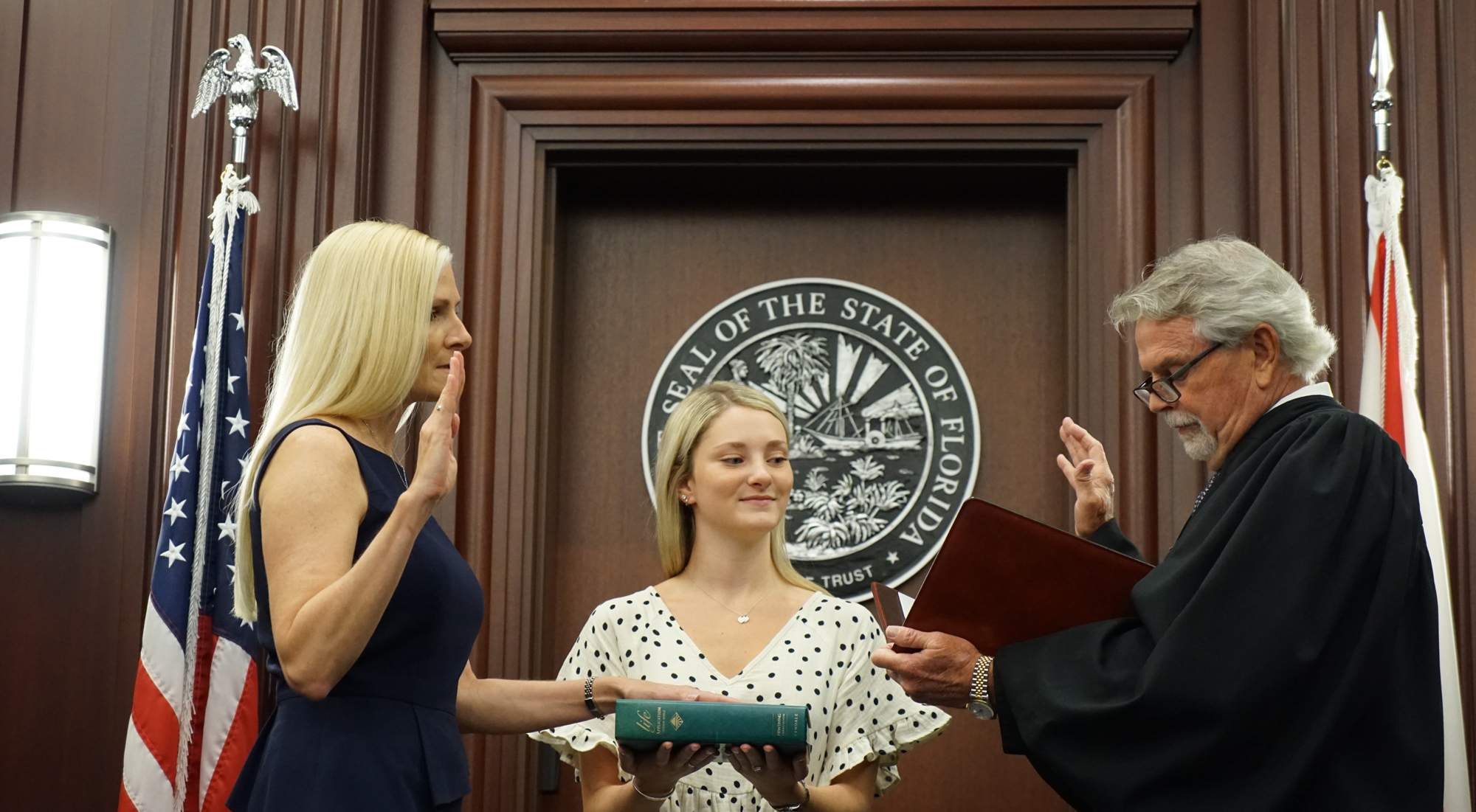 Duval County Judge Julie Taylor is sworn in by 4th Circuit Chief Judge Mark Mahon with her daughter, Shelby, holding the Bible.