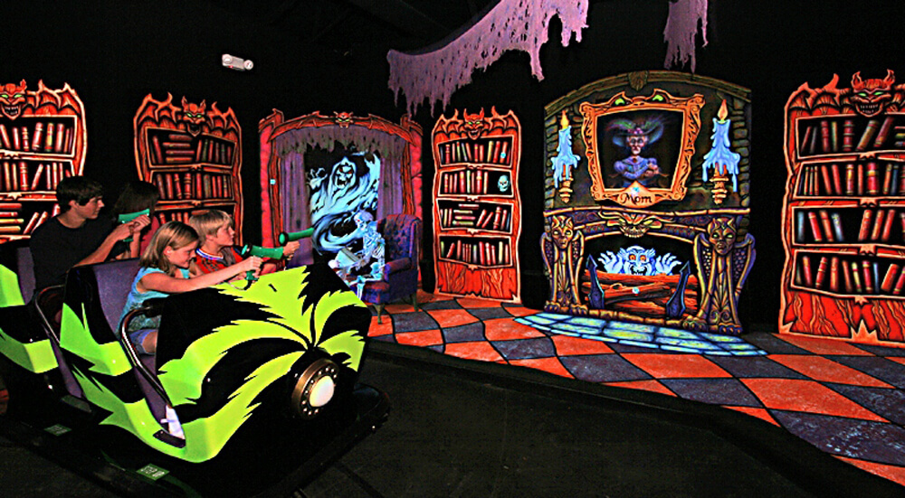 Riders on Sally’s “Ghost Blasters” ride are equipped with laser guns and score points as they shoot their way through a “haunted manor.”