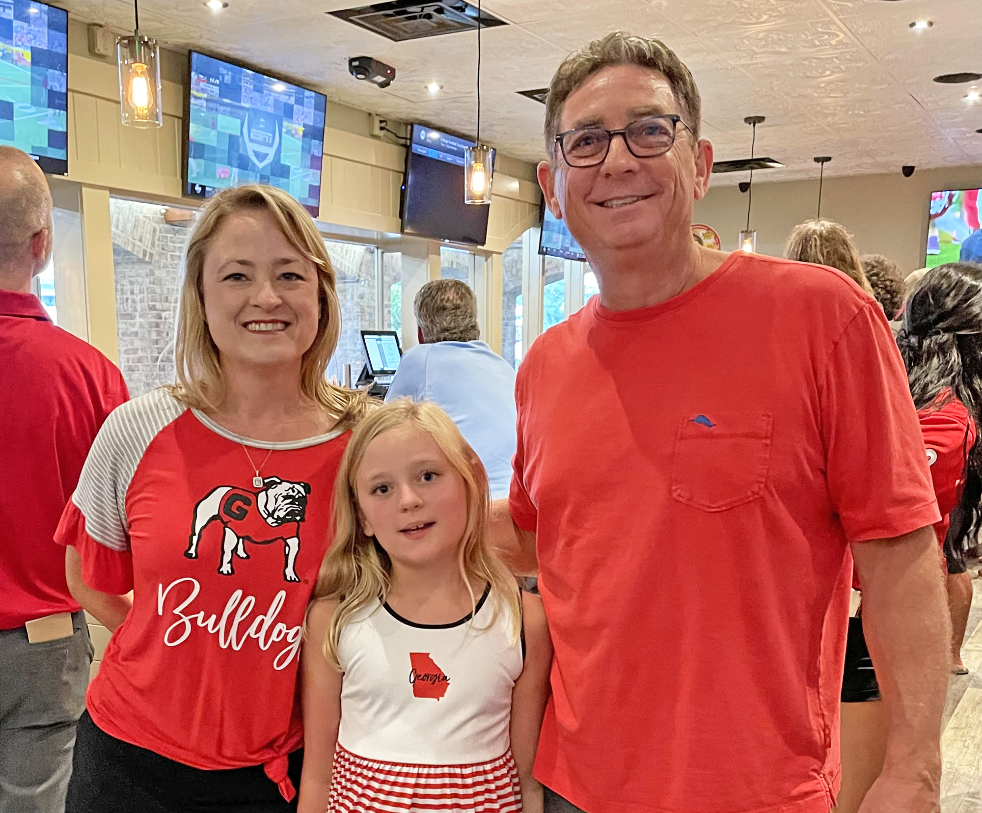 Special to the Daily Record Top Dawg Tavern founders and owners Renee and Brett Summers with their daughter, Genevieve, 9.