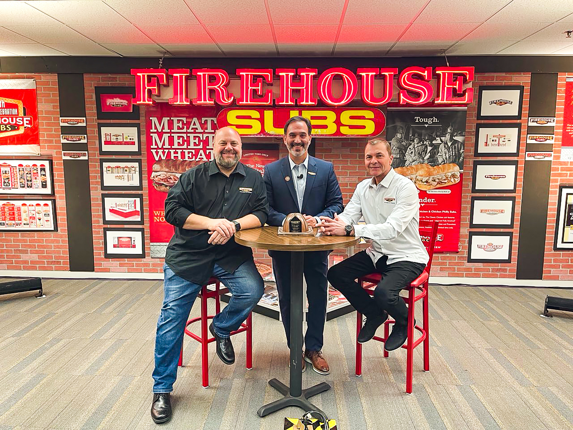 Firehouse Subs co-founders Robin Sorensen, left, and Chris Sorensen, right, with Jose Cil, CEO of Restaurant Brands International Inc. RBI agreed to buy Firehouse for $1 billion.