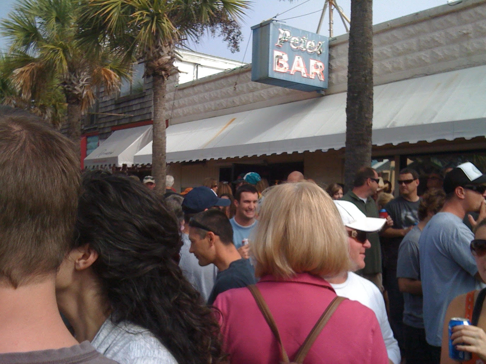 Crowds pack the street in front of Pete's Bar for the annual Thanksgiving morning party.