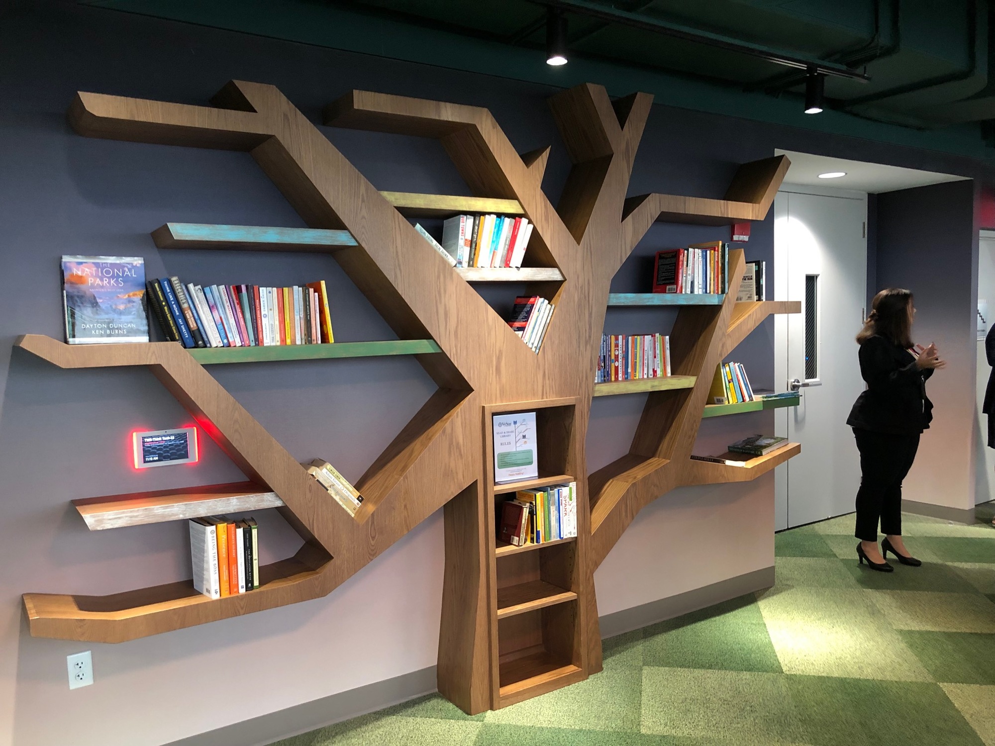 A bookcase designed as a tree features selections from the Jacksonville-based Chamblin’s Uptown.