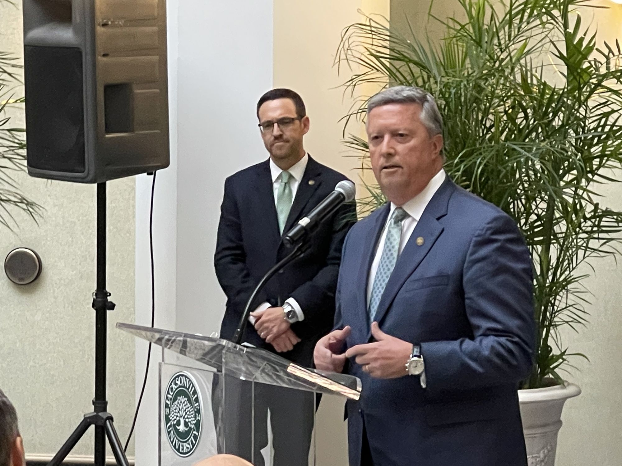 JU Senior Vice President of Marketing, Communications and University Advancement Scott Bacon, left, watches JU President Tim Cost.  (Photo by Mike Mendenhall)