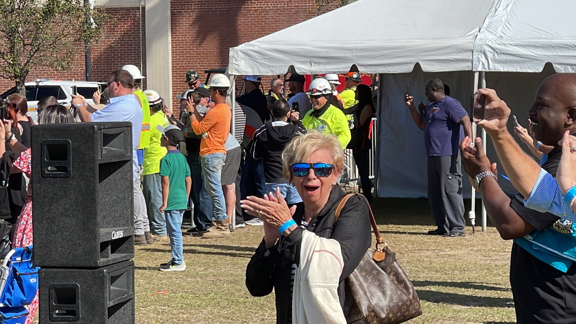 Carole Pece, the mother of demolition contractor Pece of Mind Environmental Inc. owner Steve Pece, watches he implosion.