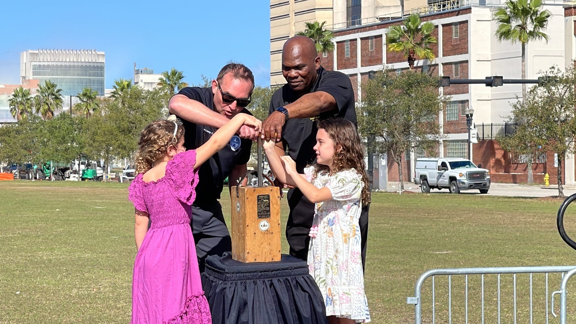 Jacksonville Mayor Lenny Curry, Council member Reggie Gaffney and the daughters of demolition company owner Steve Pece, 7-year-old Haven and 6-year old Blythe, pushed the ceremonial plunger to signal the implosion.