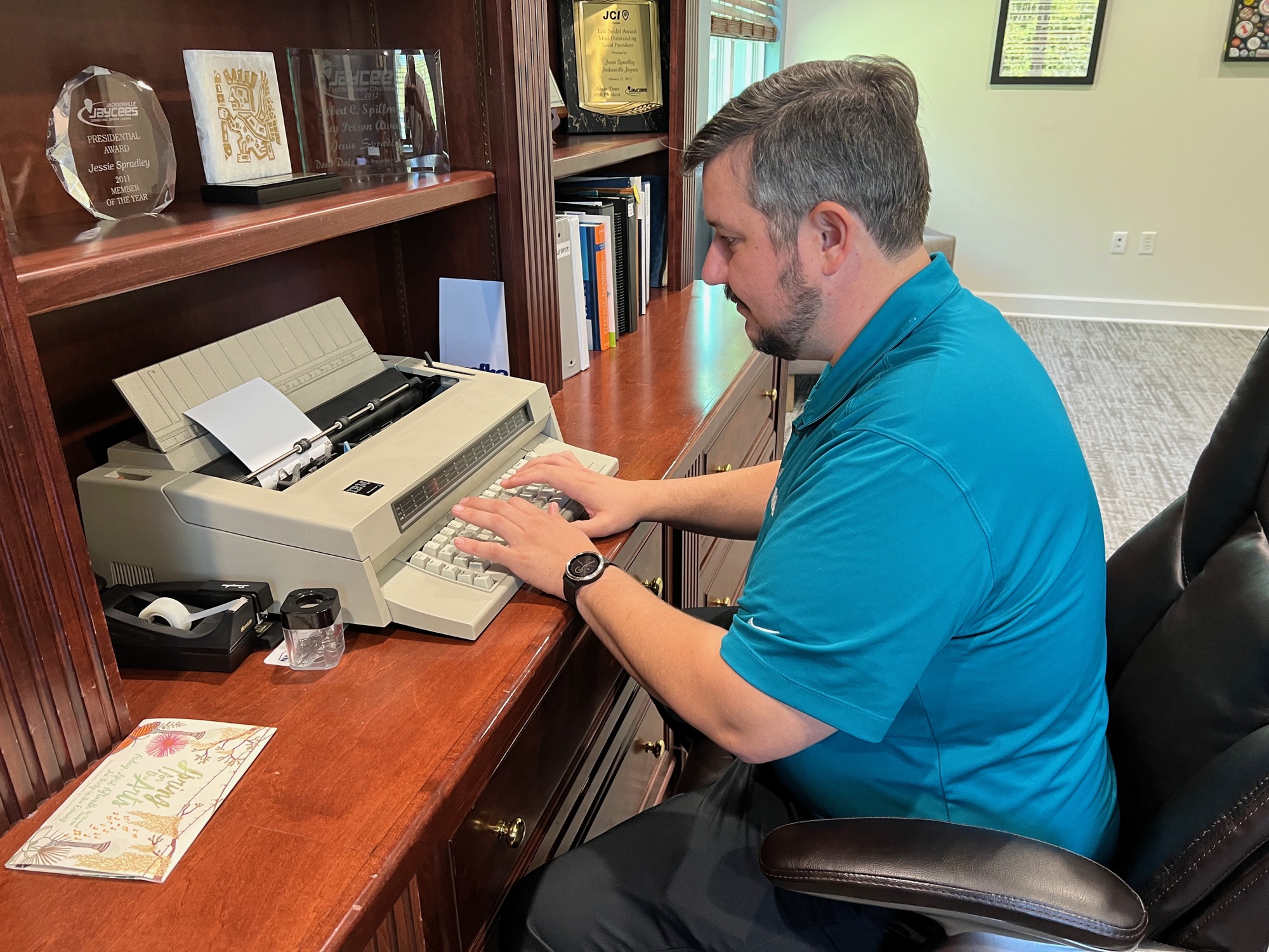 Jessie Spradley has an unusual piece of equipment in his NEFBA office – a typewriter. He prefers it to a word processor to send personal notes to members.