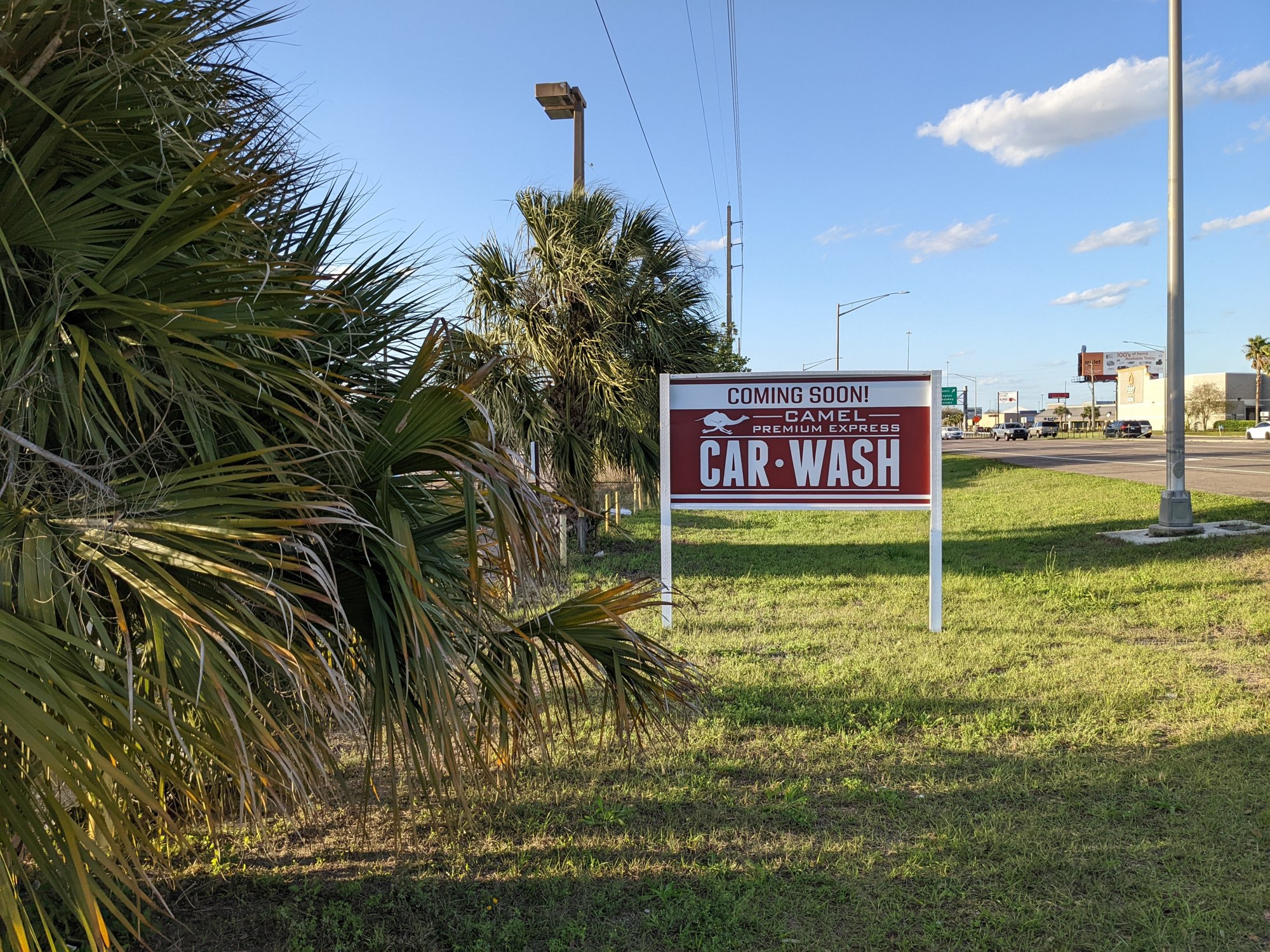 There is a sign along the property for Camel Premium Express Car Wash.