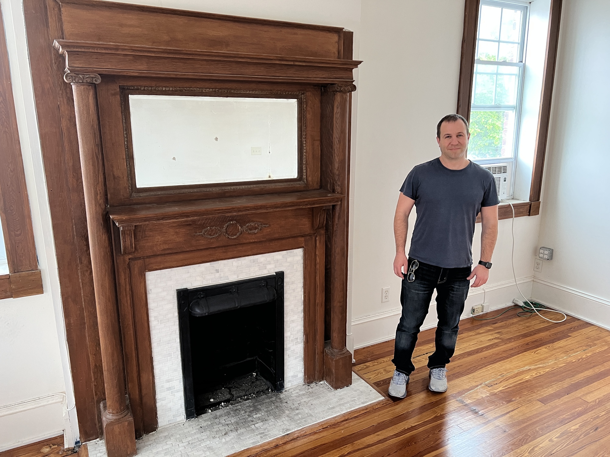 Eric Adler, the owner of the Pratt Funeral Home, shows one of the many nonworking fireplaces inside the building. Adler says he intends to keep the fireplaces when he renovates the property into an Airbnb.