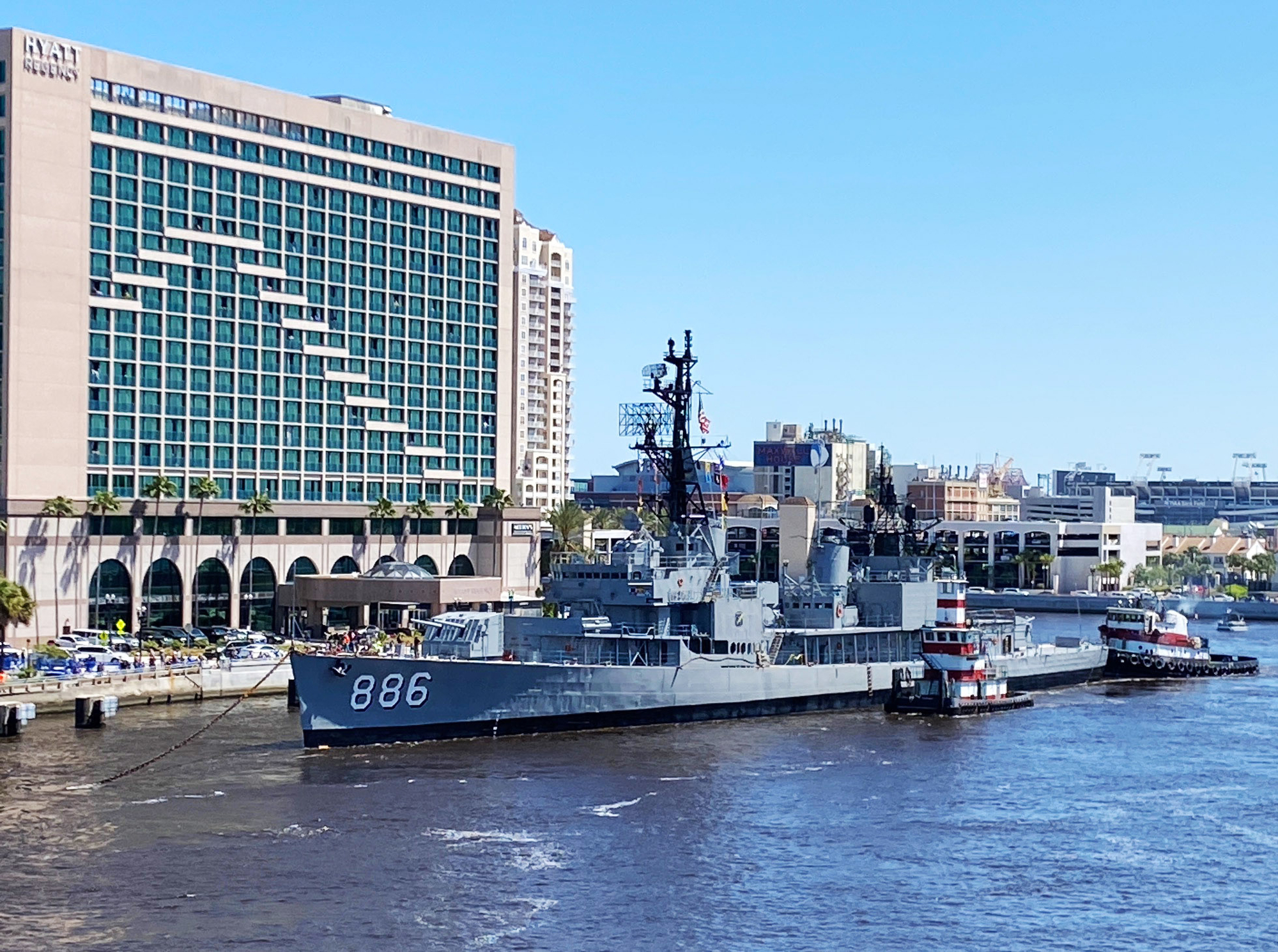 The USS Orleck sits alongside the Hyatt Regency Jacksonville Riverfront hotel Downtown.