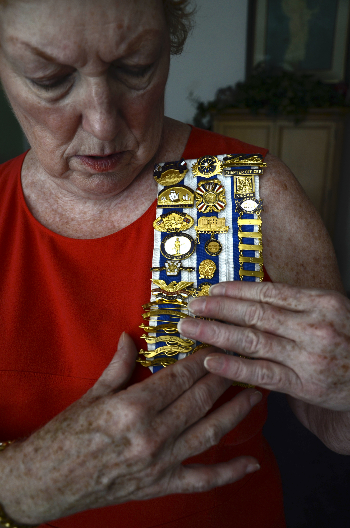 McFate proudly displays her collection of DAR pins, which include the names of her family members who participated in the Revolutionary War.