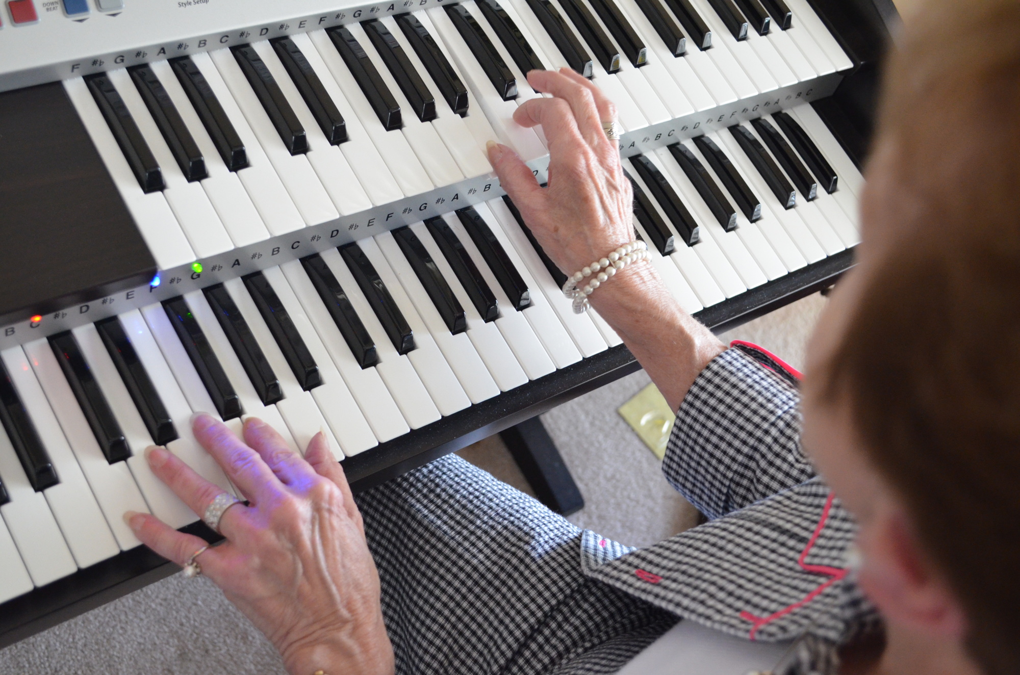 The keyboard Loretta Schwaner plays differs from a piano because it has two keyboards and electronic arrangements to accompany the player.