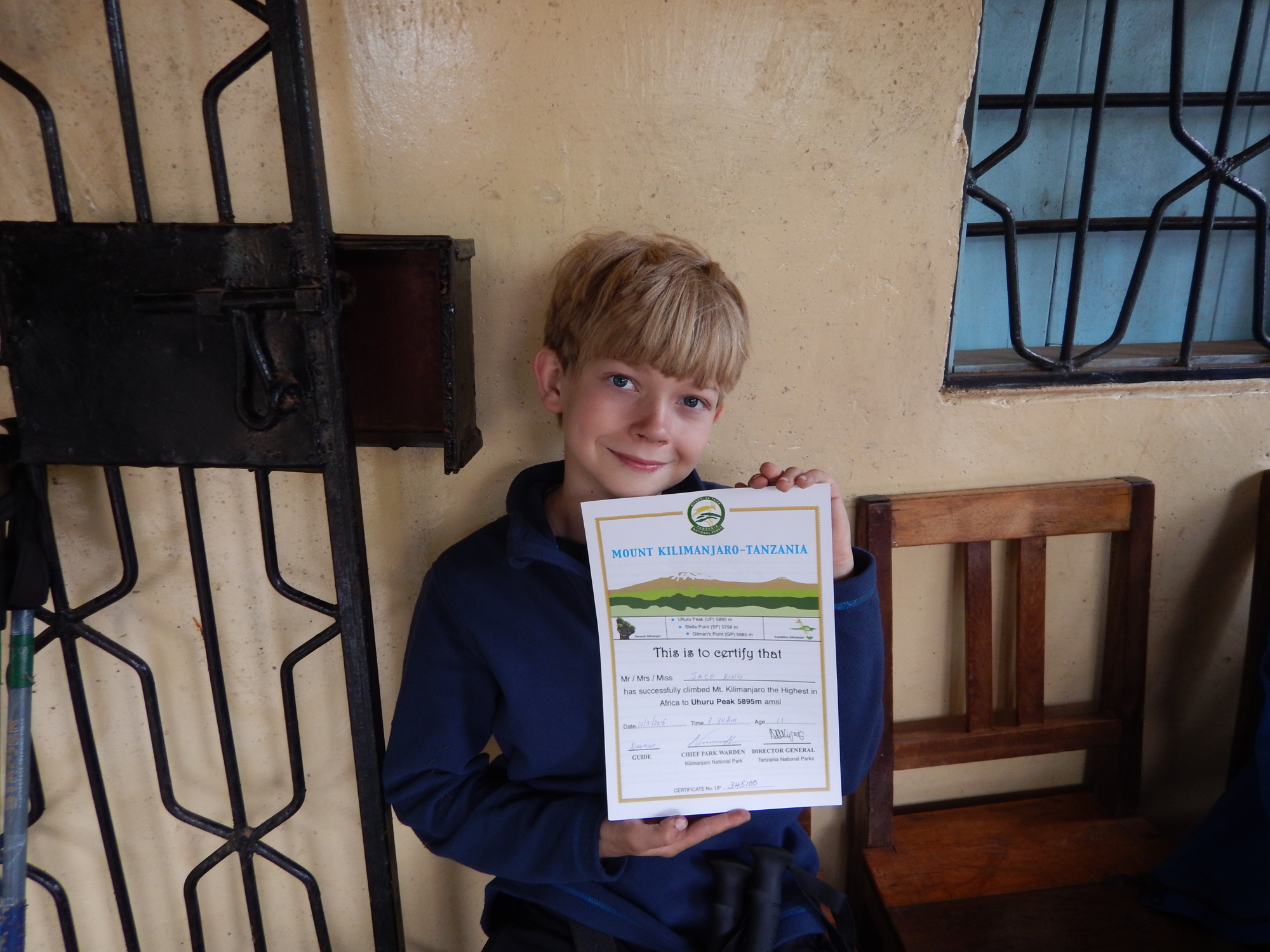 Jace King receives a certificate for his successful summit of Mount Kilimanjaro.