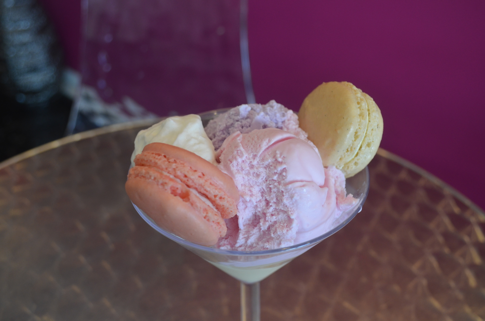 Le Macaron’s gelato sundae, made with violet flower, candy strawberry and vanilla bean gelato flavors, rose petals and Madagascar black vanilla macaroons and whipped cream.